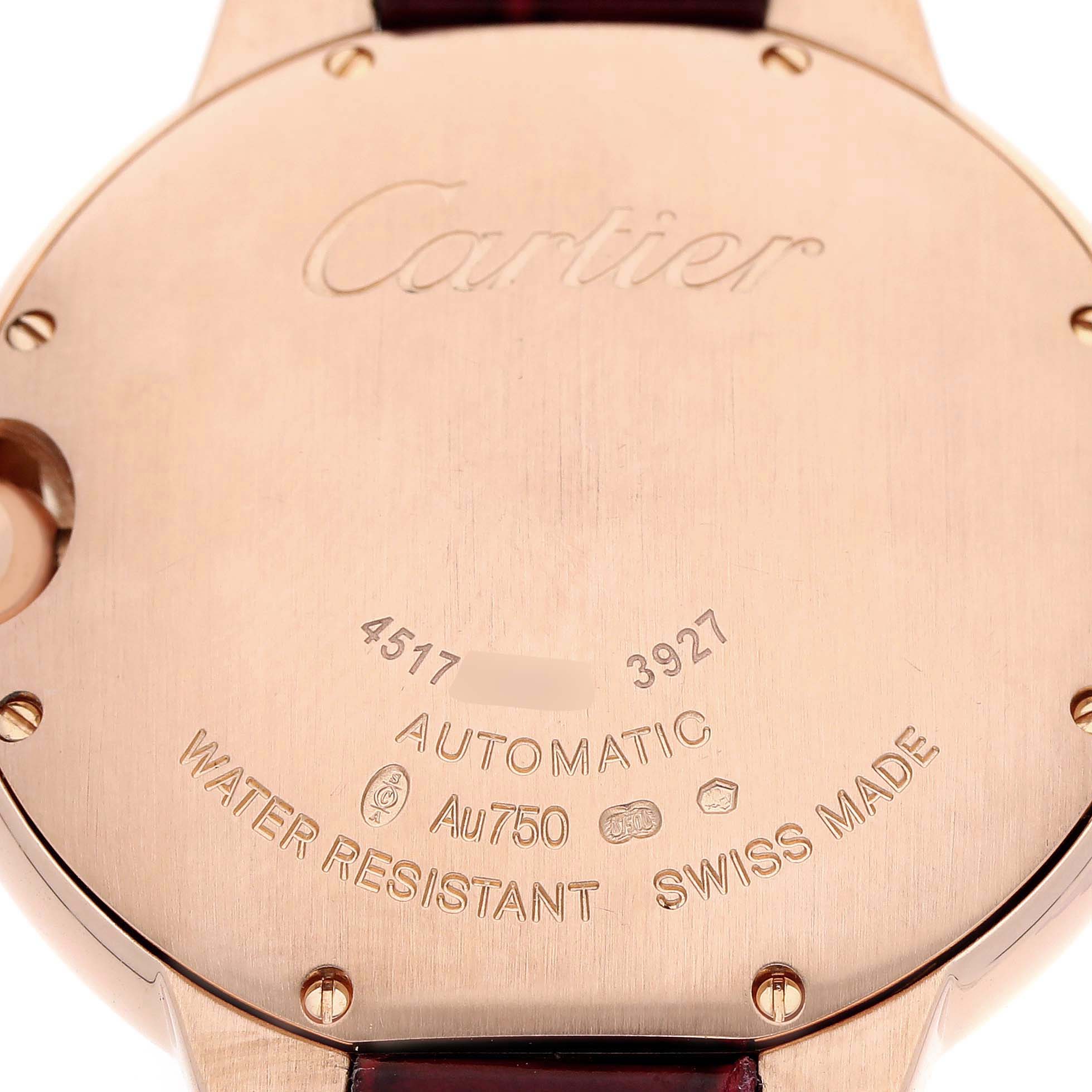 The image shows the back case of a Cartier Ballon Bleu WJBB0010 Women's Rose Gold Silver Dial watch, featuring engravings and gold detailing.