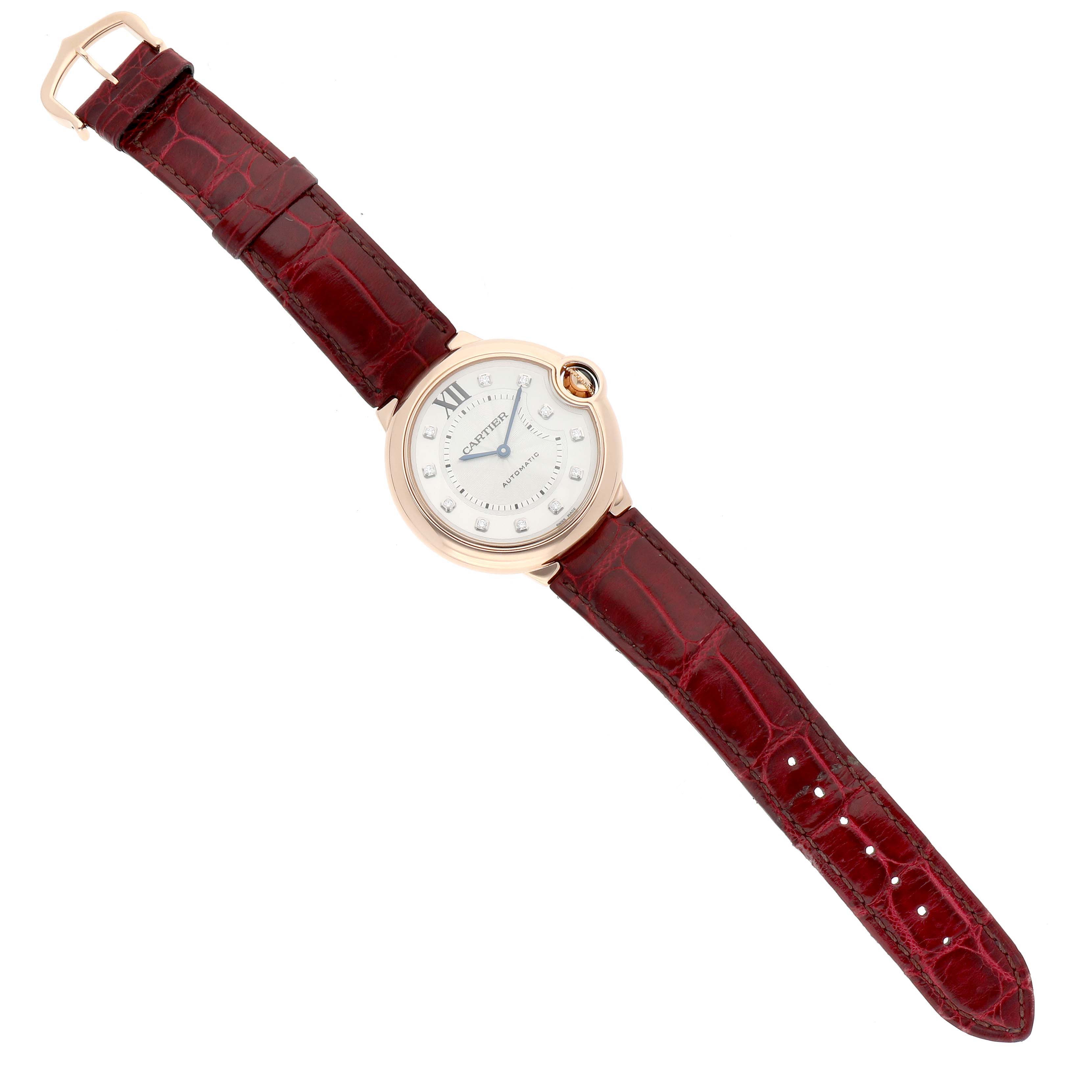 The Cartier Ballon Bleu WJBB0010 Women's Rose Gold Silver Dial watch is shown from a top-down angle, displaying the face, bezel, and full strap.