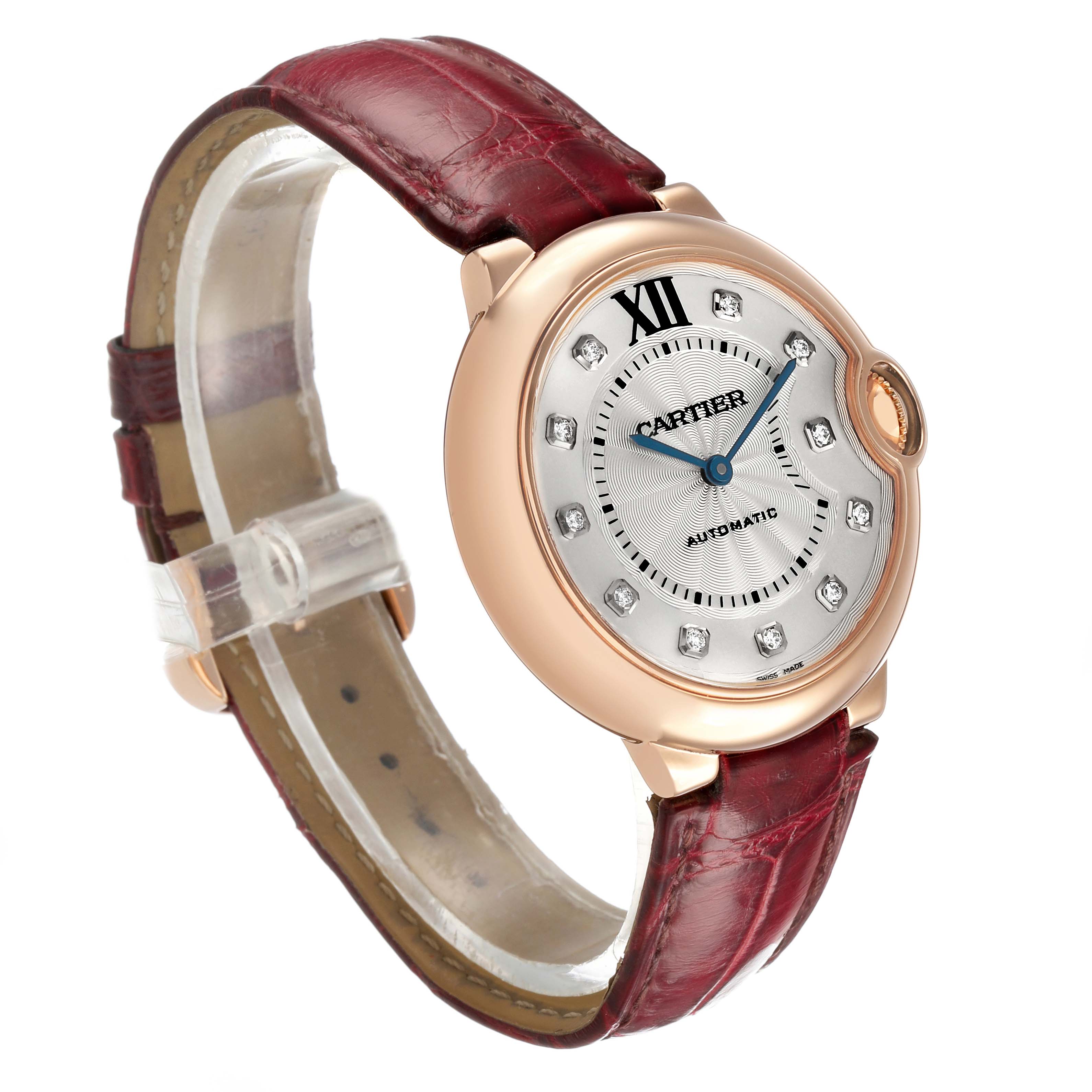 The Cartier Ballon Bleu WJBB0010 Women's Rose Gold Silver Dial watch is shown from an angled view, highlighting its dial, crown, and burgundy leather strap.