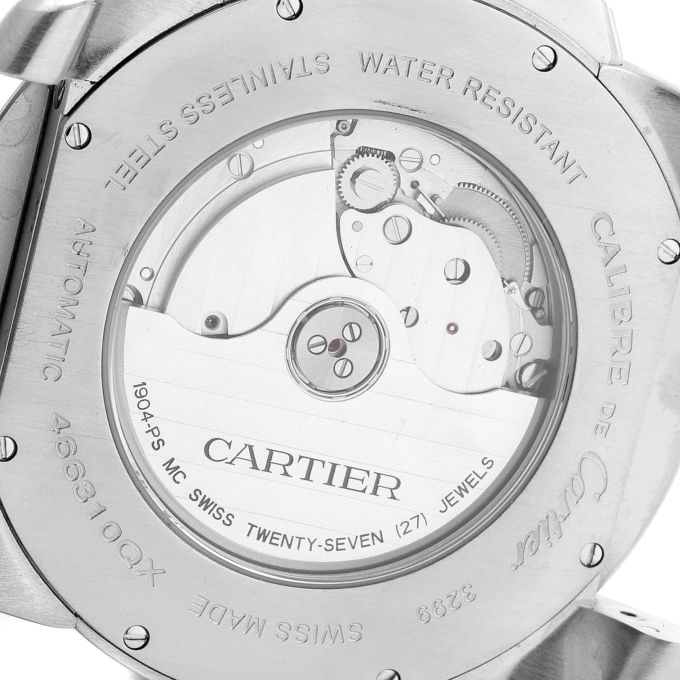 The image shows the back of the Calibre de Cartier watch by Cartier, highlighting the exposed mechanical movement and engravings.