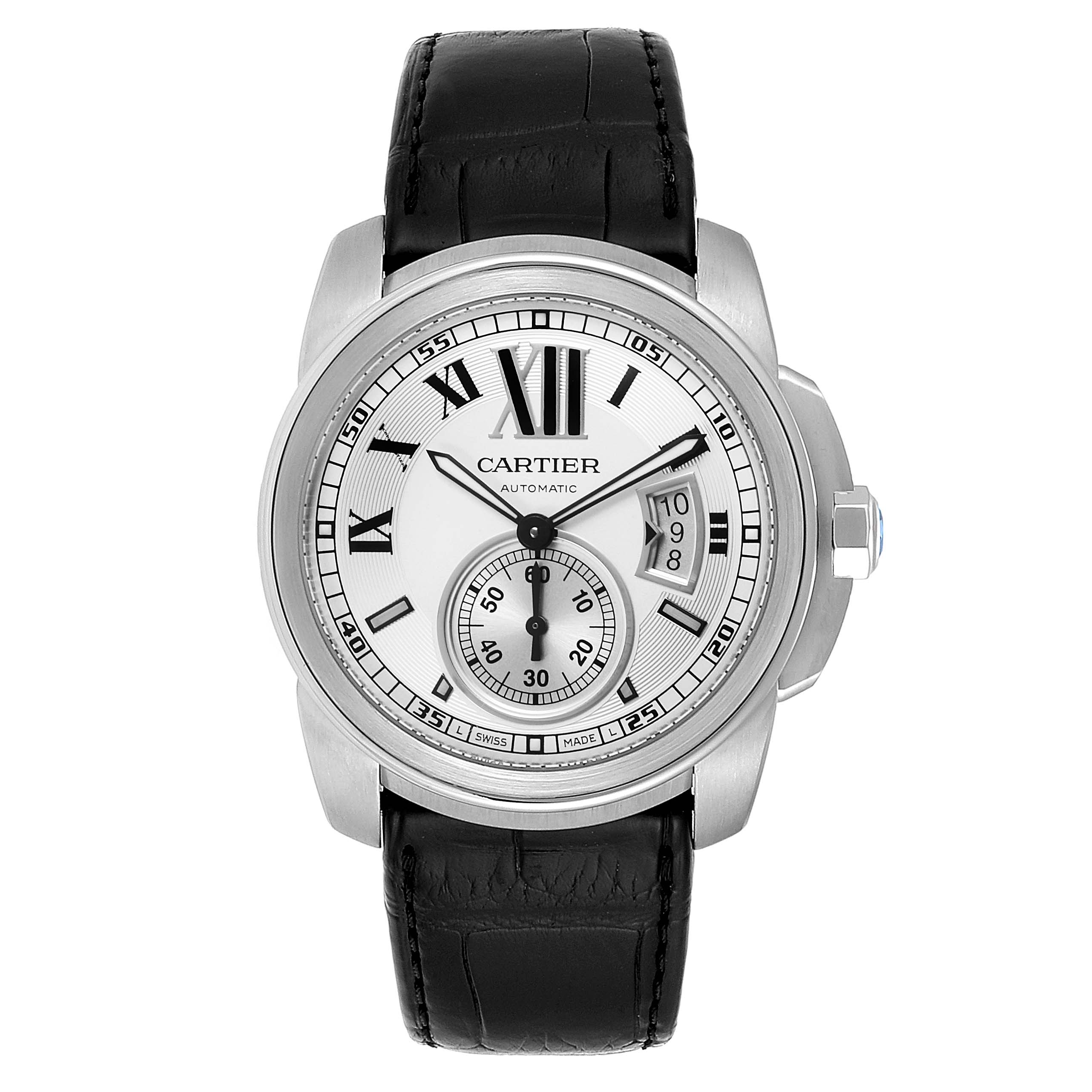 The image shows a front view of the Calibre de Cartier watch by Cartier, displaying the dial, hands, and black leather strap.