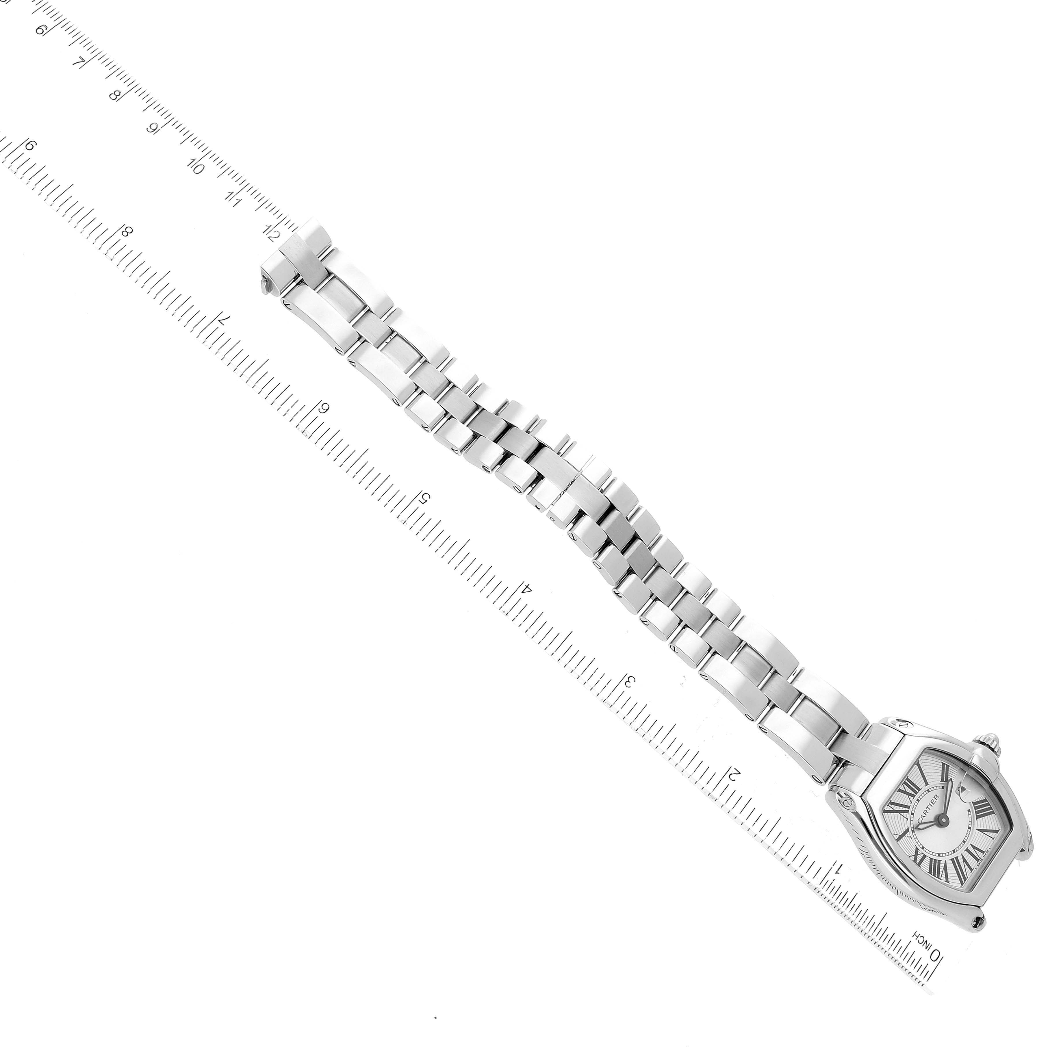 The image shows a Cartier Roadster W62016V3 Women
s Stainless Steel Silver Dial W62016V3 Women
s Stainless Steel Silver Dial watch laid at an angle with the face and bracelet fully visible, aligned with a measuring scale.