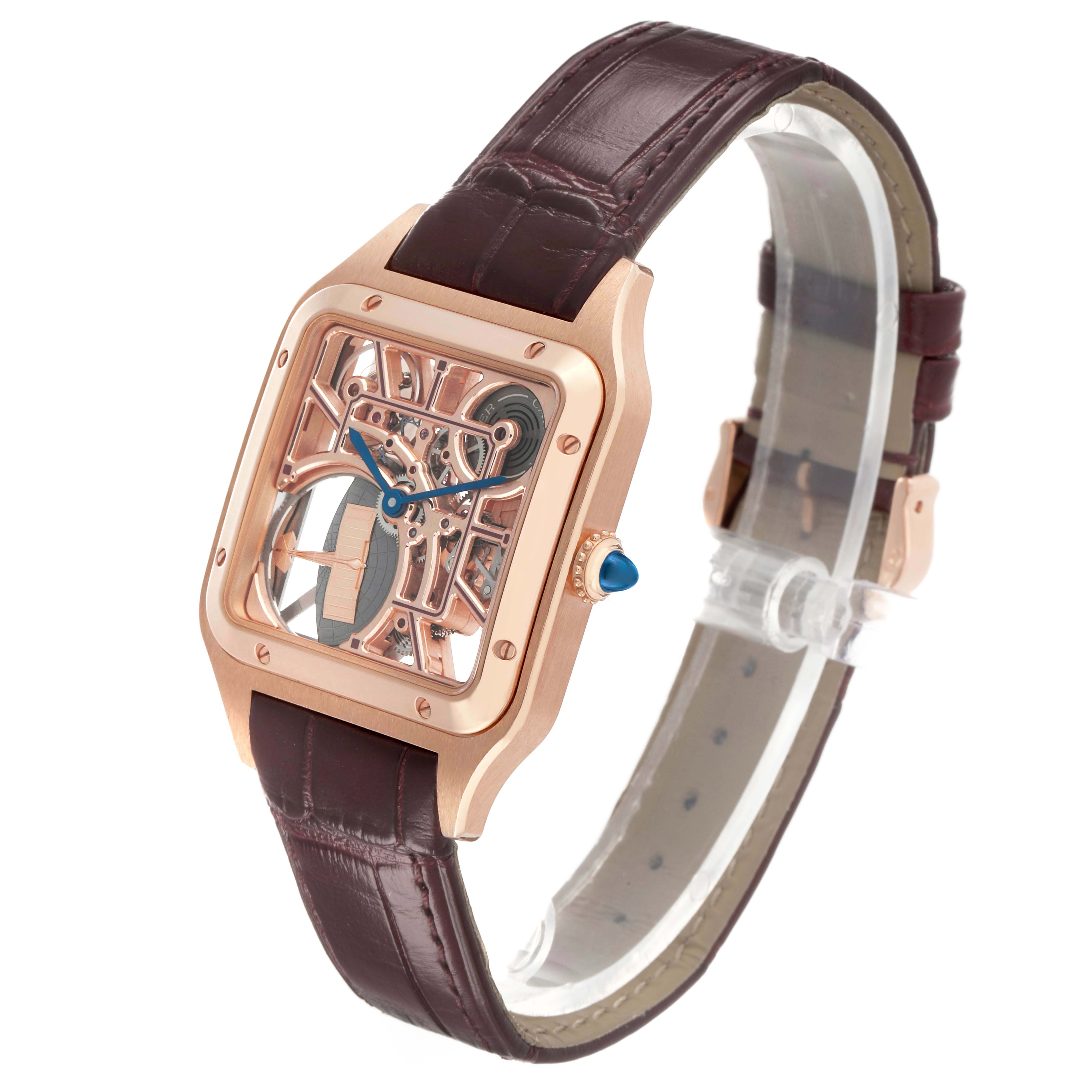 The Cartier Santos Dumont WHSA0030 Men's Rose Gold Transparent Dial watch is shown at a three-quarter view, highlighting its skeletal dial, side crown, and leather strap.