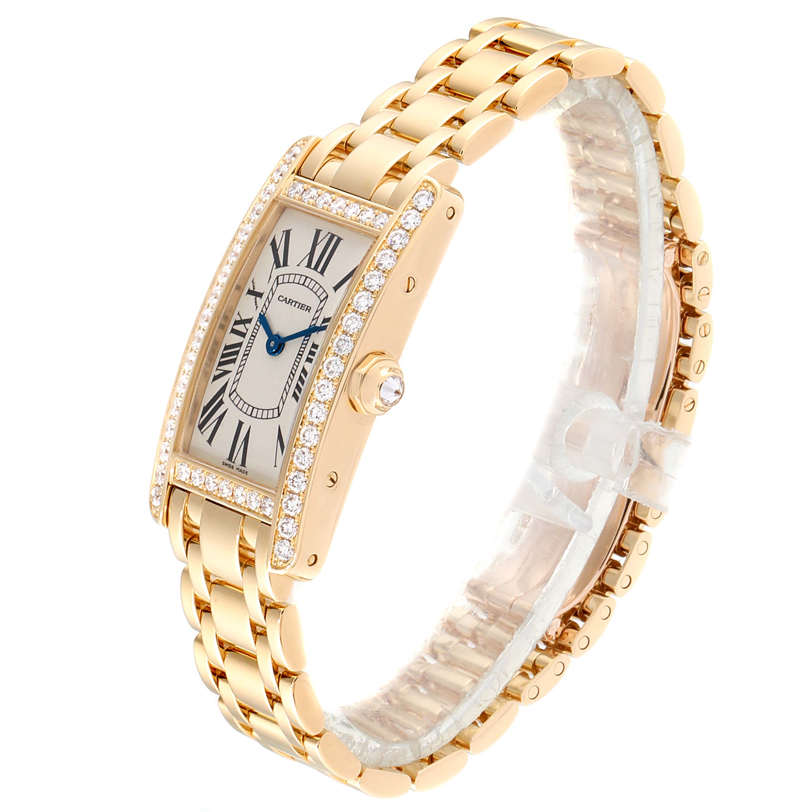 The image shows an angled side view of a Cartier Tank Americaine WB7072K2 Women's Yellow Gold Silver Dial WB7072K2 Women's Yellow Gold Silver Dial watch, showcasing its gold bracelet, diamond bezel, and rectangular dial.
