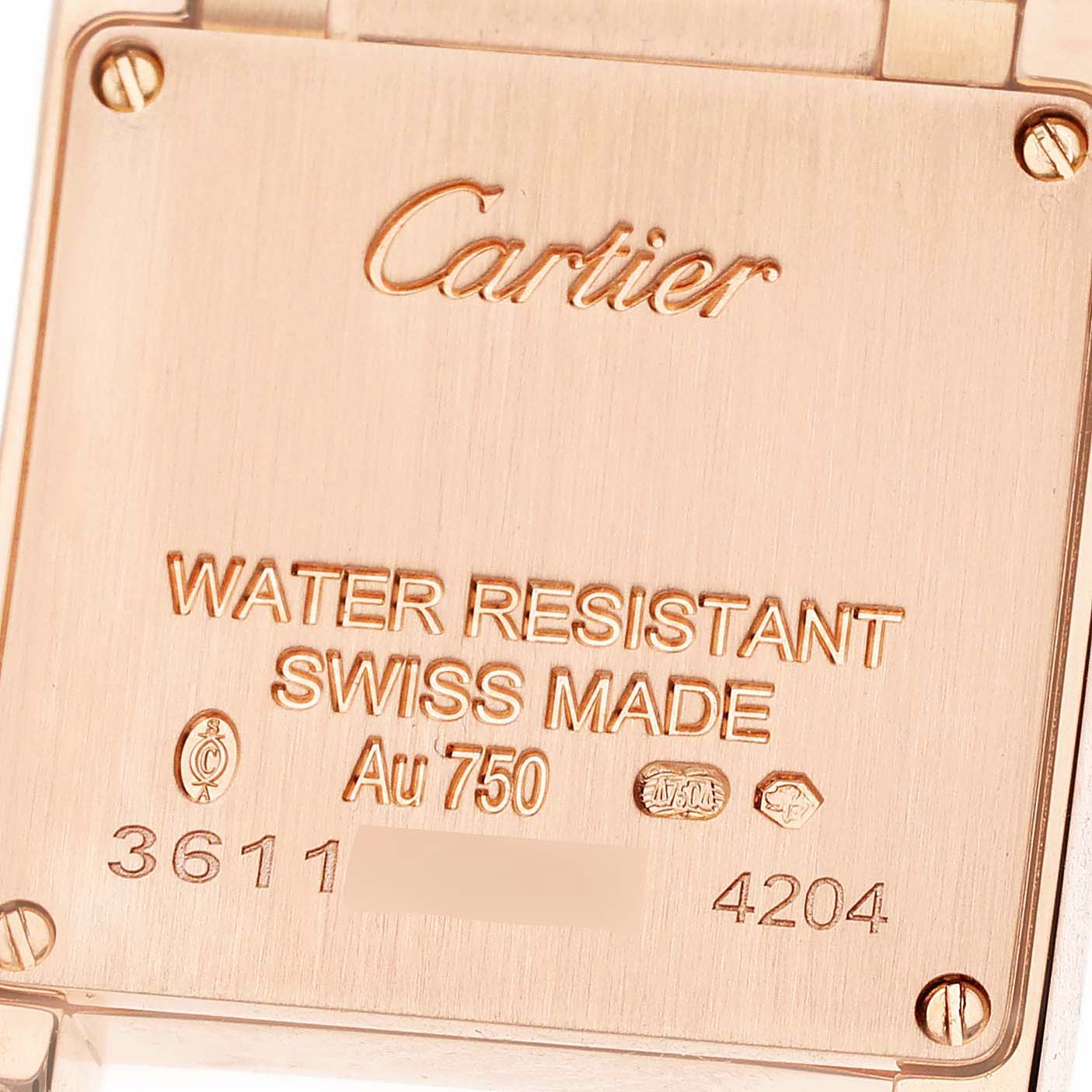 The image shows the caseback of a Cartier Tank Française watch in a close-up shot.