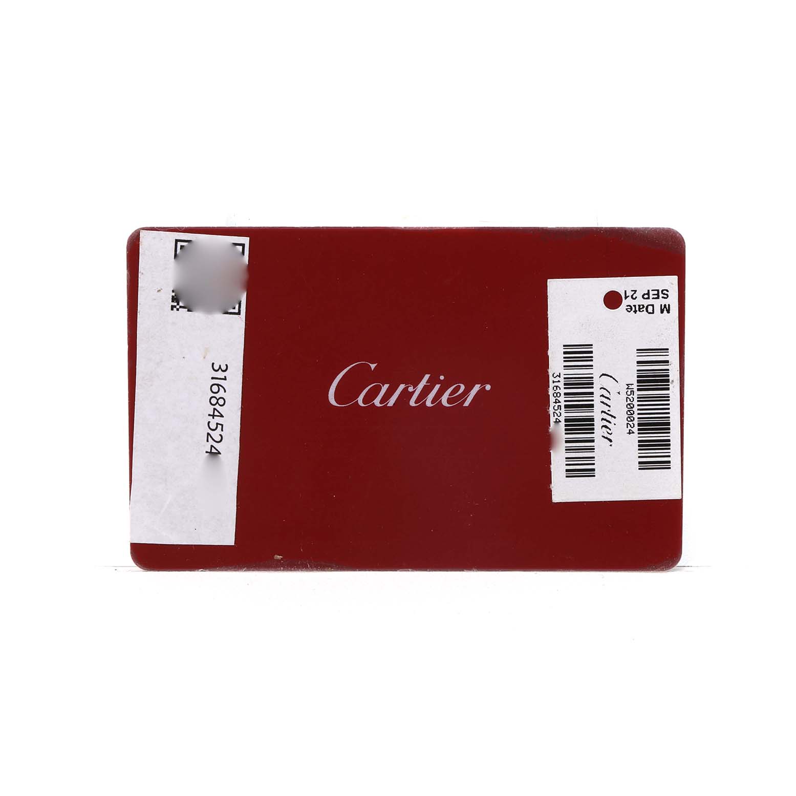 The image shows a red Cartier card with text and barcodes related to the Tank Solo model.