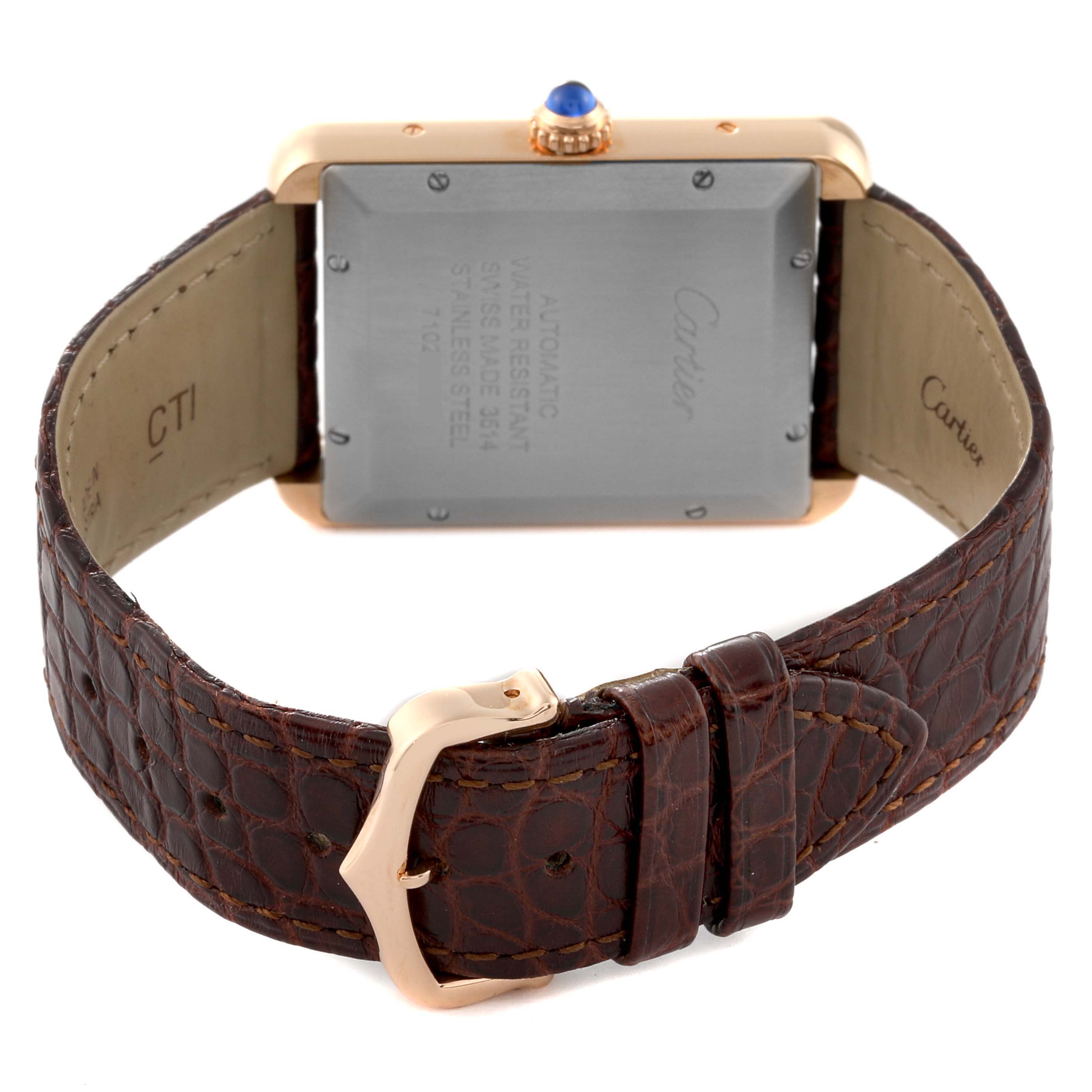 The image shows the back view of a Cartier Tank Solo W5200026 Men
s Steel and Gold (two tone) Silver Dial W5200026 Men
s Steel and Gold (two tone) Silver Dial watch, highlighting its clasp, leather strap, and case back.