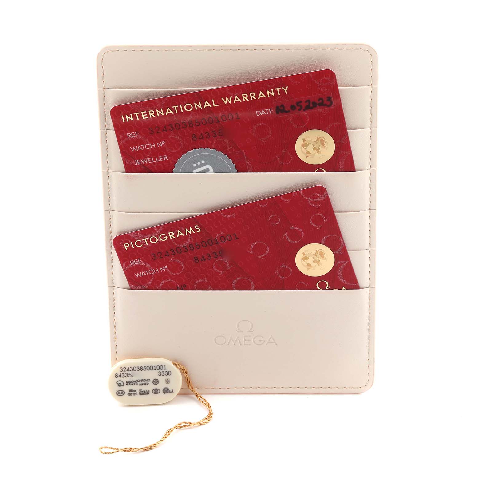 The image shows Omega Speedmaster 324.30.38.50.01.001 Men
s Stainless Steel Black Dial 324.30.38.50.01.001 Men
s Stainless Steel Black Dial accessories, including a warranty cardholder and a hang tag with details.