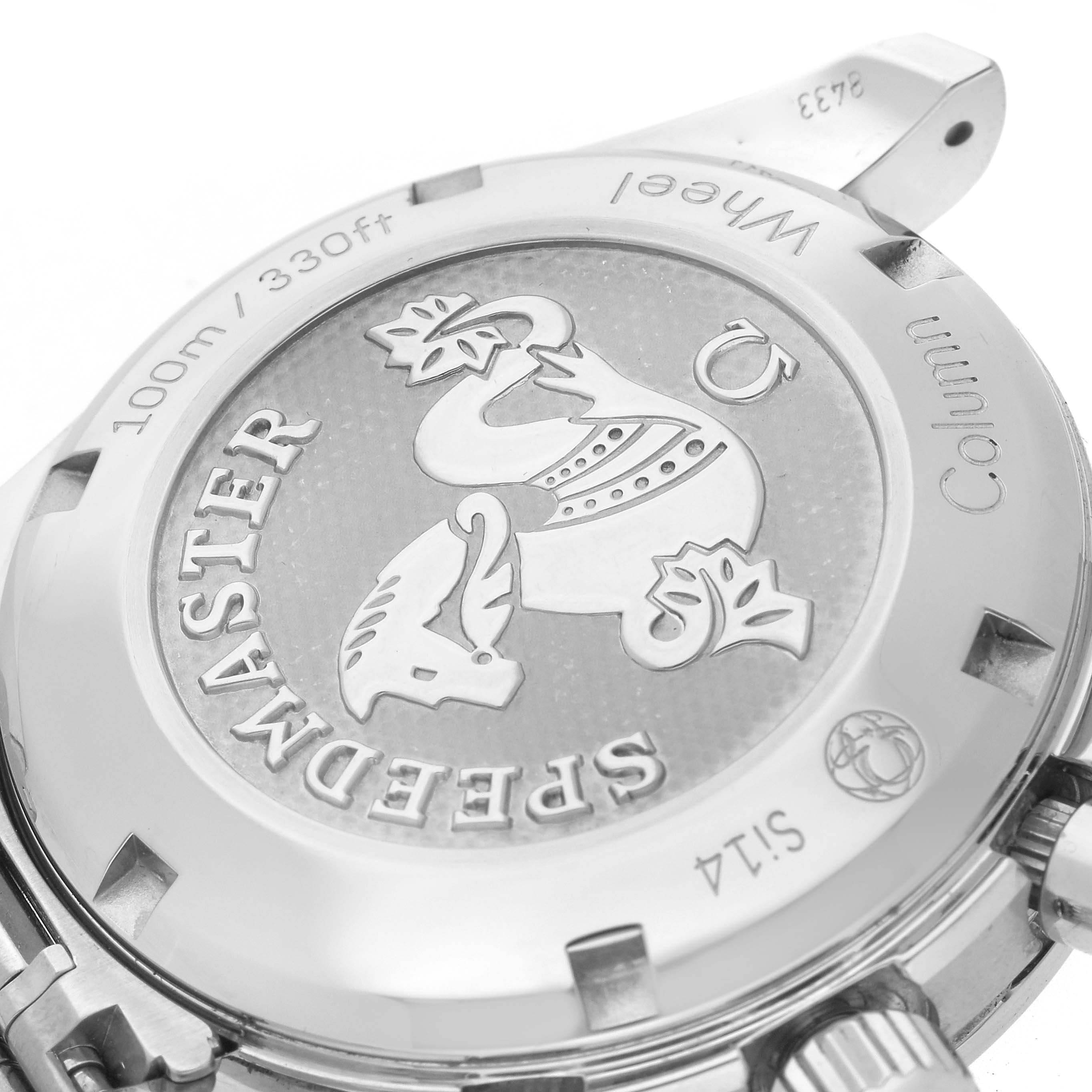 The image shows the back casing of an Omega Speedmaster 324.30.38.50.01.001 Men
s Stainless Steel Black Dial 324.30.38.50.01.001 Men
s Stainless Steel Black Dial watch, featuring engraved text and emblem details.