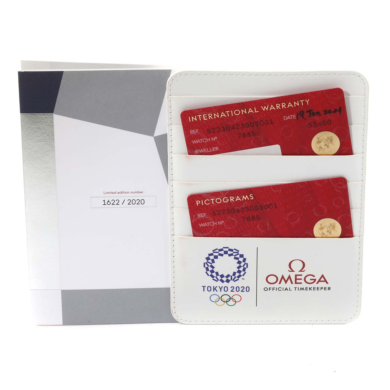 The image shows warranty and pictogram cards for an Omega Speedmaster 522.30.42.30.03.001 Men's Stainless Steel Blue Dial 522.30.42.30.03.001 Men's Stainless Steel Blue Dial, with a booklet in the background.