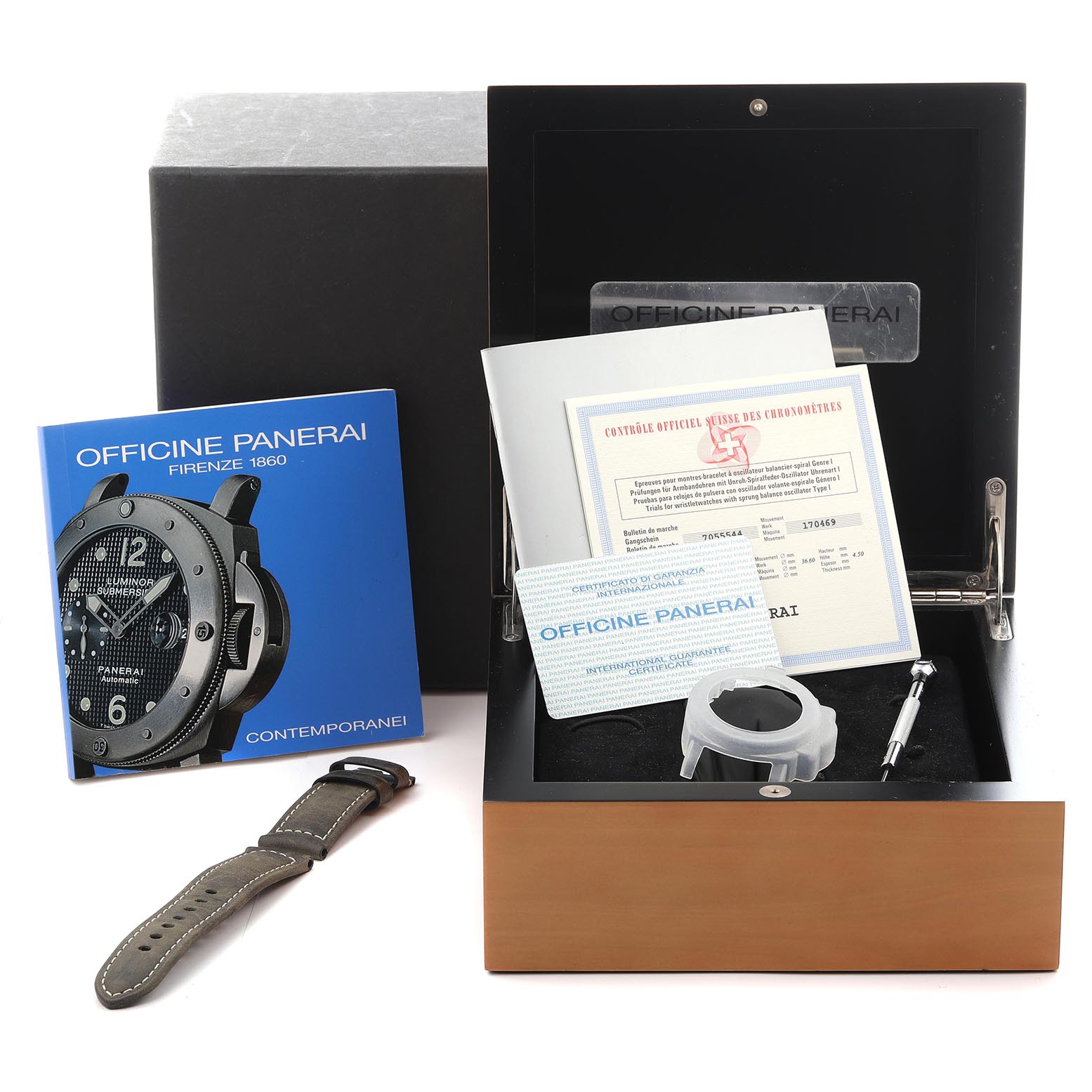 The Panerai Luminor PAM00029 Men's Stainless Steel Black Dial PAM00029 Men's Stainless Steel Black Dial box includes documentation, a strap, a tool, and a protective case, all displayed from a top-down angle.