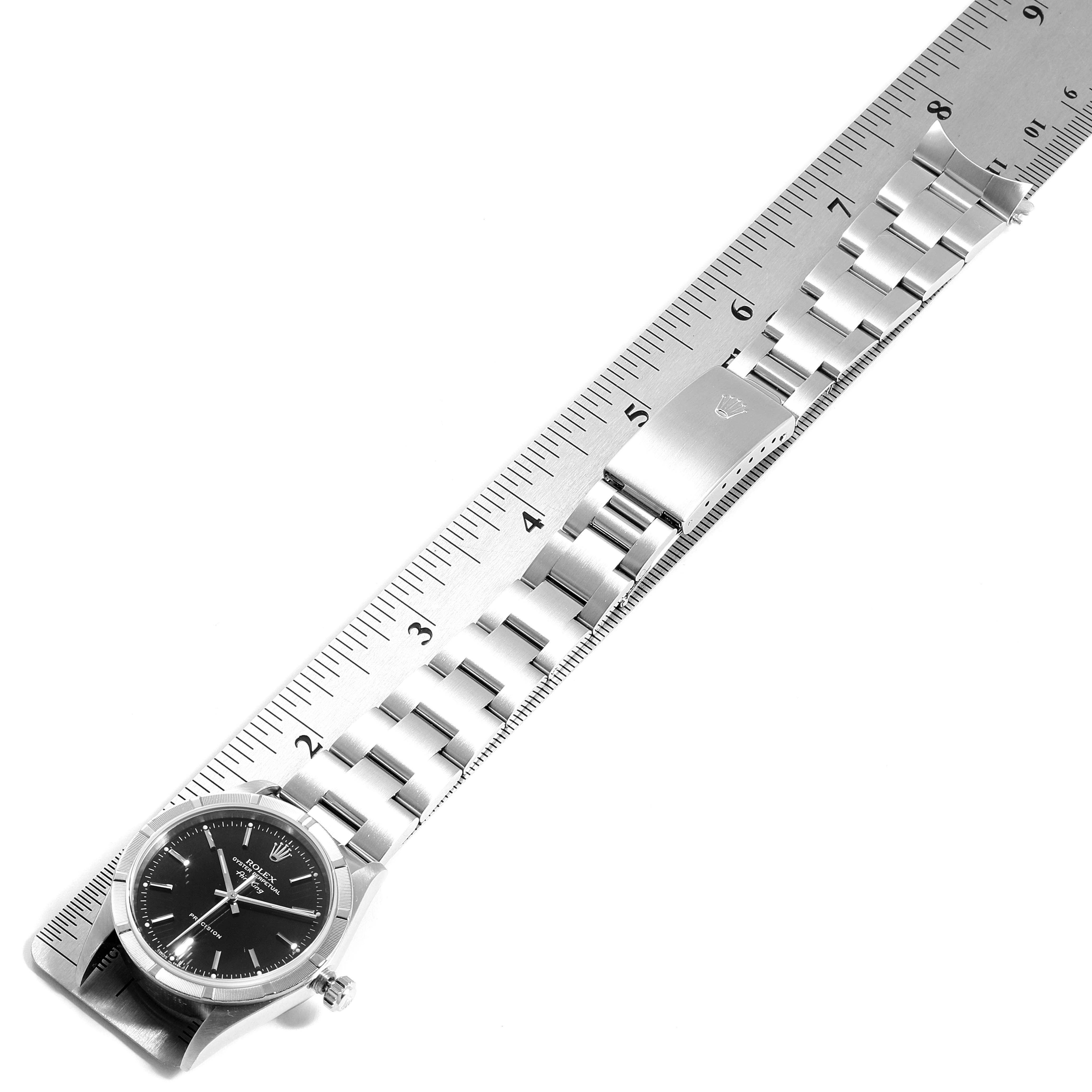 The image shows a Rolex Air-King 14010 Men's Stainless Steel Black Dial 14010 Men's Stainless Steel Black Dial watch placed flat alongside a ruler, highlighting its bracelet and clasp.