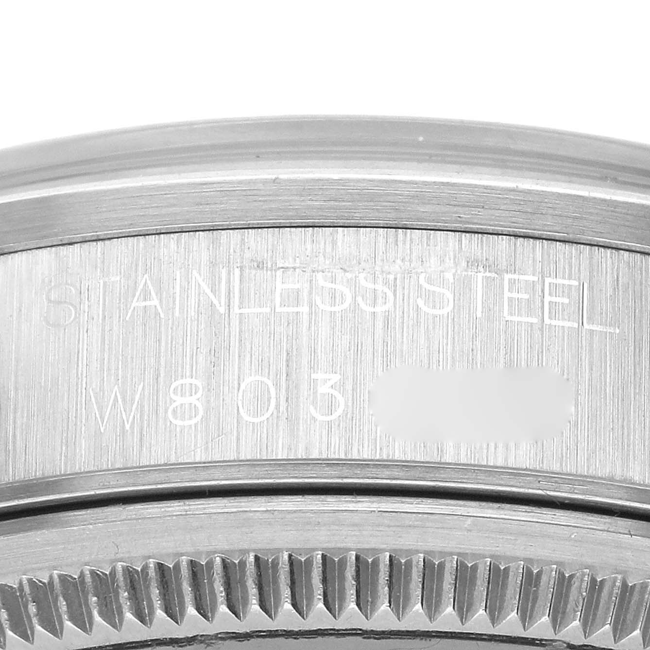 This close-up image shows the stainless steel engraving and part of the bezel serration of a Rolex Air-King 14000 Men's Stainless Steel Black Dial 14000 Men's Stainless Steel Black Dial watch.
