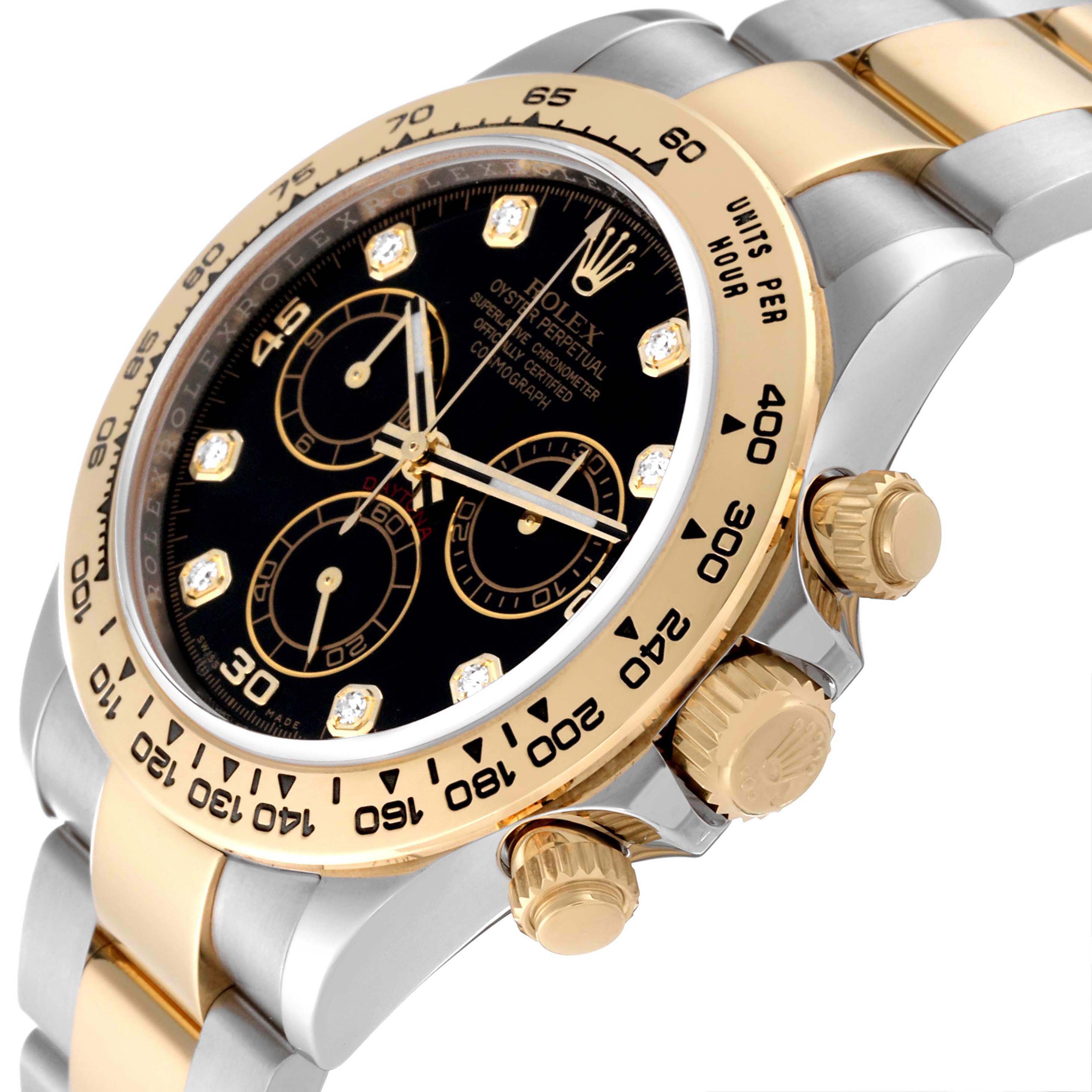 The image displays a side angle of the Rolex Daytona 116503 Men
s Steel and Gold (two tone) Black Dial 116503 Men
s Steel and Gold (two tone) Black Dial watch, highlighting its bezel, crown, pushers, and part of the bracelet.
