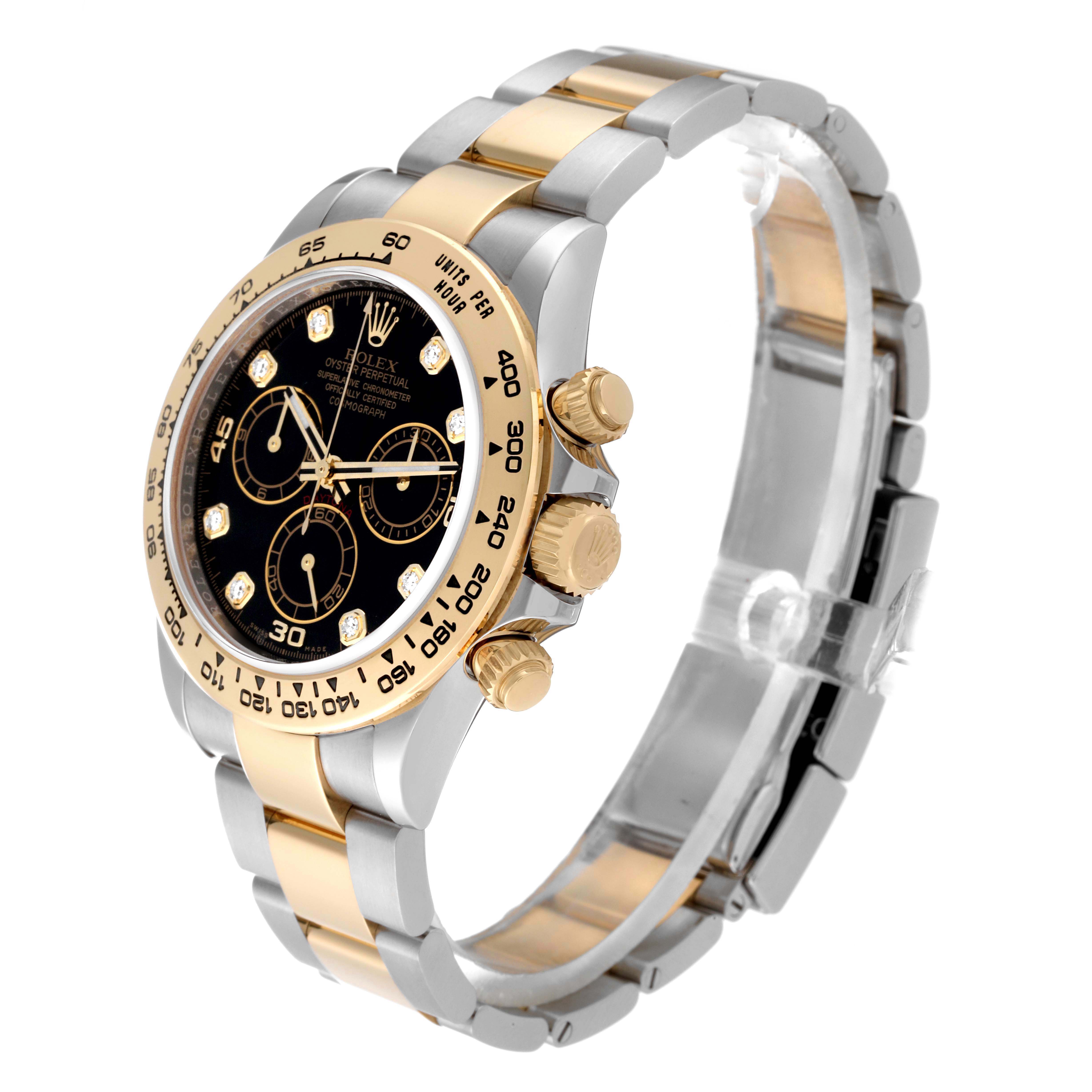 The image shows a Rolex Daytona 116503 Men
s Steel and Gold (two tone) Black Dial 116503 Men
s Steel and Gold (two tone) Black Dial watch at an angle showcasing its face, bezel, crown, and two-tone metal bracelet.