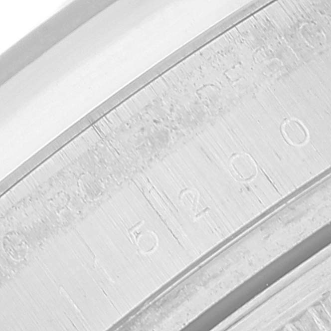 This close-up image shows the engraved serial numbers and 'Rolex Design' text on the side of the Date model by Rolex.
