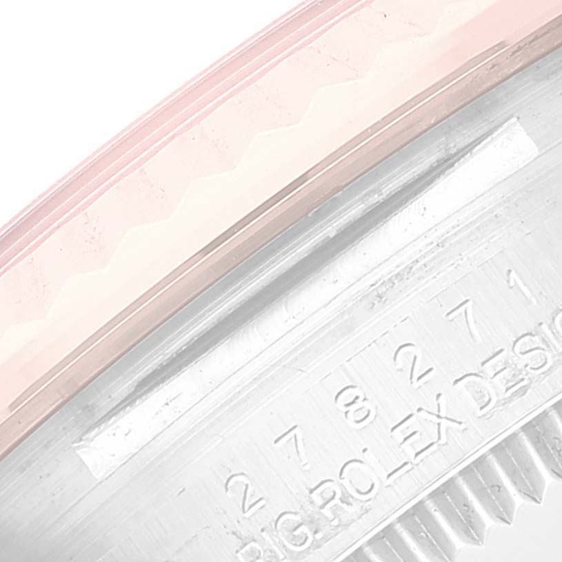 The image shows a close-up of the bezel and engraved details of a Rolex Mid-Size 278271 Women's Steel and Gold (two tone) Pink Dial 278271 Women's Steel and Gold (two tone) Pink Dial model watch, highlighting the numbers and letters.