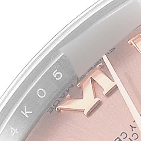 The image shows an angled close-up of the dial and bezel of a Rolex Mid-Size 278271 Women's Steel and Gold (two tone) Pink Dial 278271 Women's Steel and Gold (two tone) Pink Dial watch, highlighting part of a number and the edge detail.