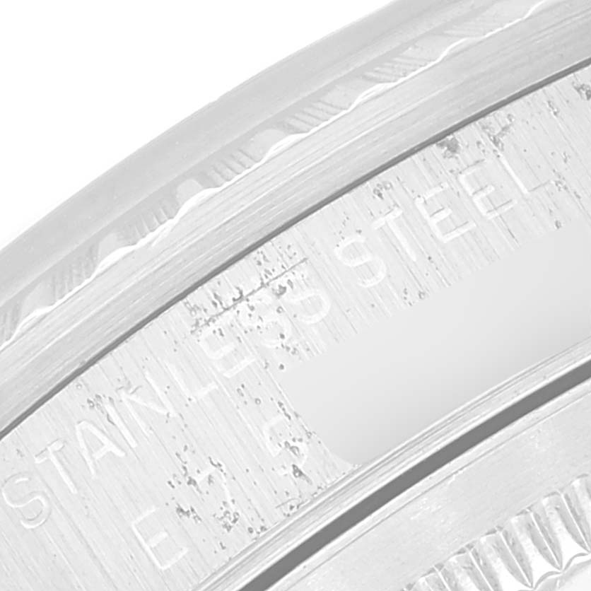 This is a close-up image of the bezel and part of the casing showing "STAINLESS STEEL" engraving on a Rolex Datejust 16220 Men's Stainless Steel Pink Dial 16220 Men's Stainless Steel Pink Dial watch.