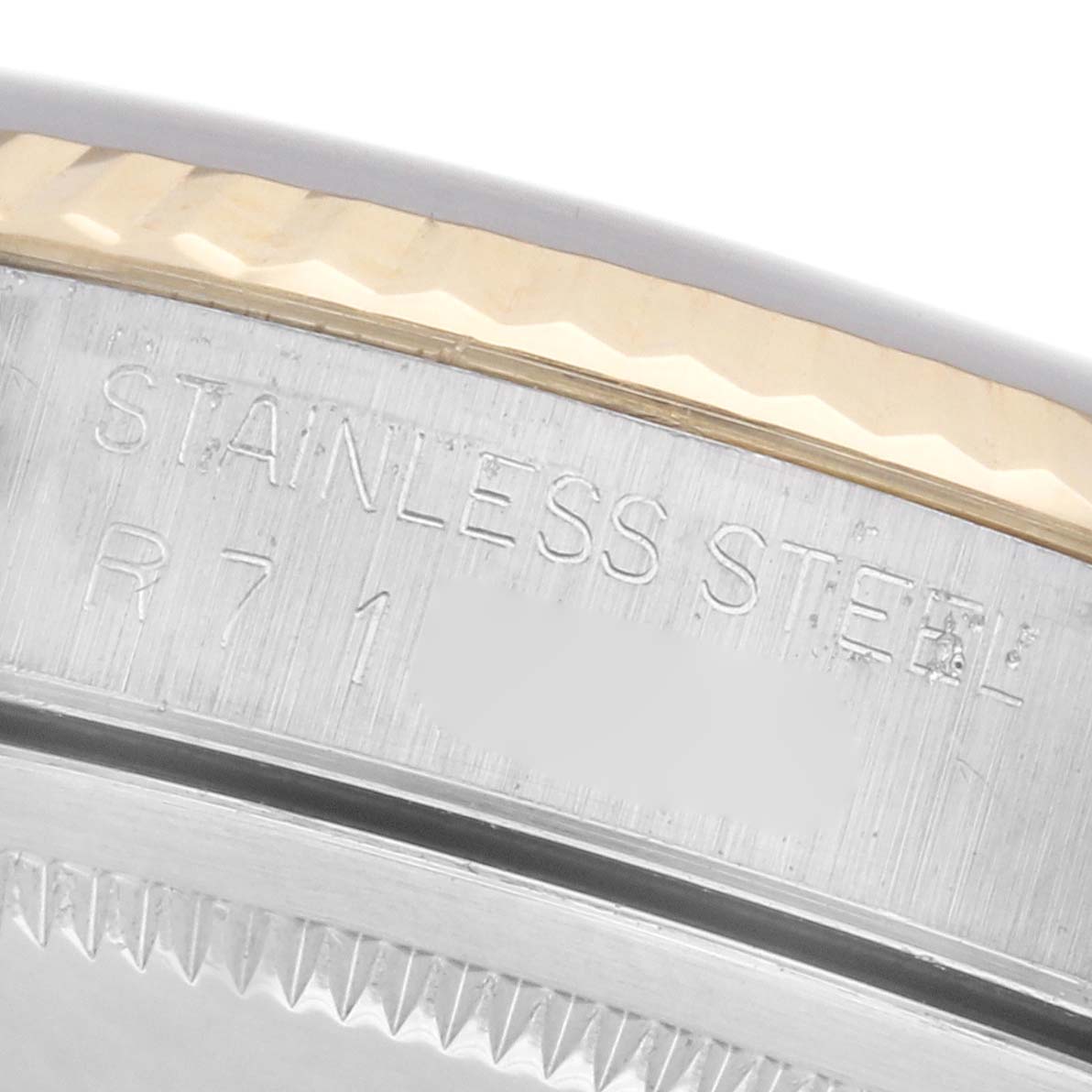 The image shows the case back edge and part of the bezel of a Rolex Datejust 16233 Men
s Steel and Gold (two tone) Champagne Dial 16233 Men
s Steel and Gold (two tone) Champagne Dial, highlighting its stainless steel material.