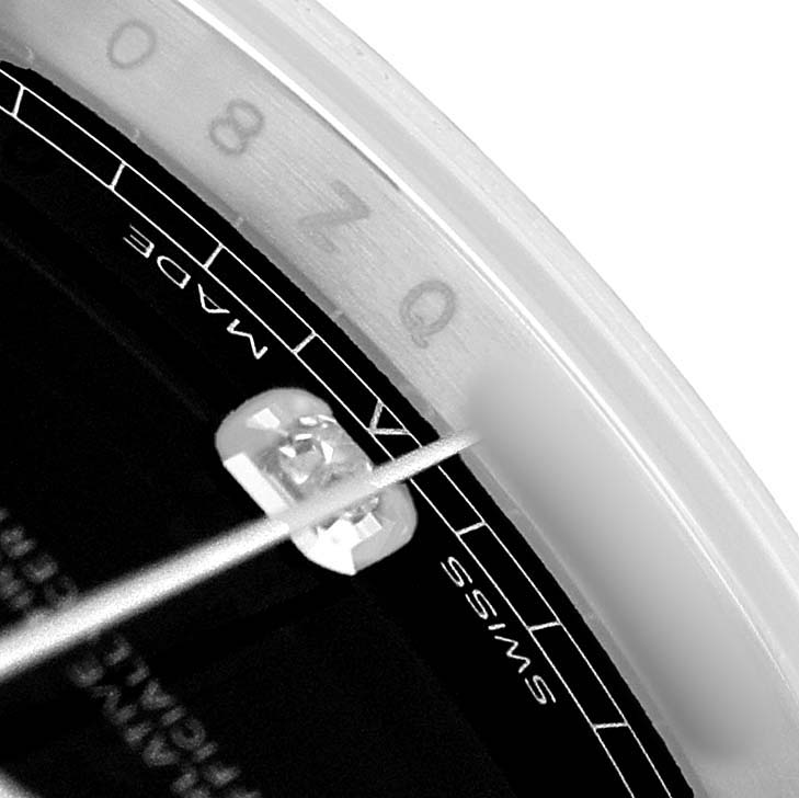 This close-up of the Rolex Datejust 41 126334 Men's Stainless Steel Grey Dial watch focuses on the date magnification lens and part of the dial showing "SWISS MADE."