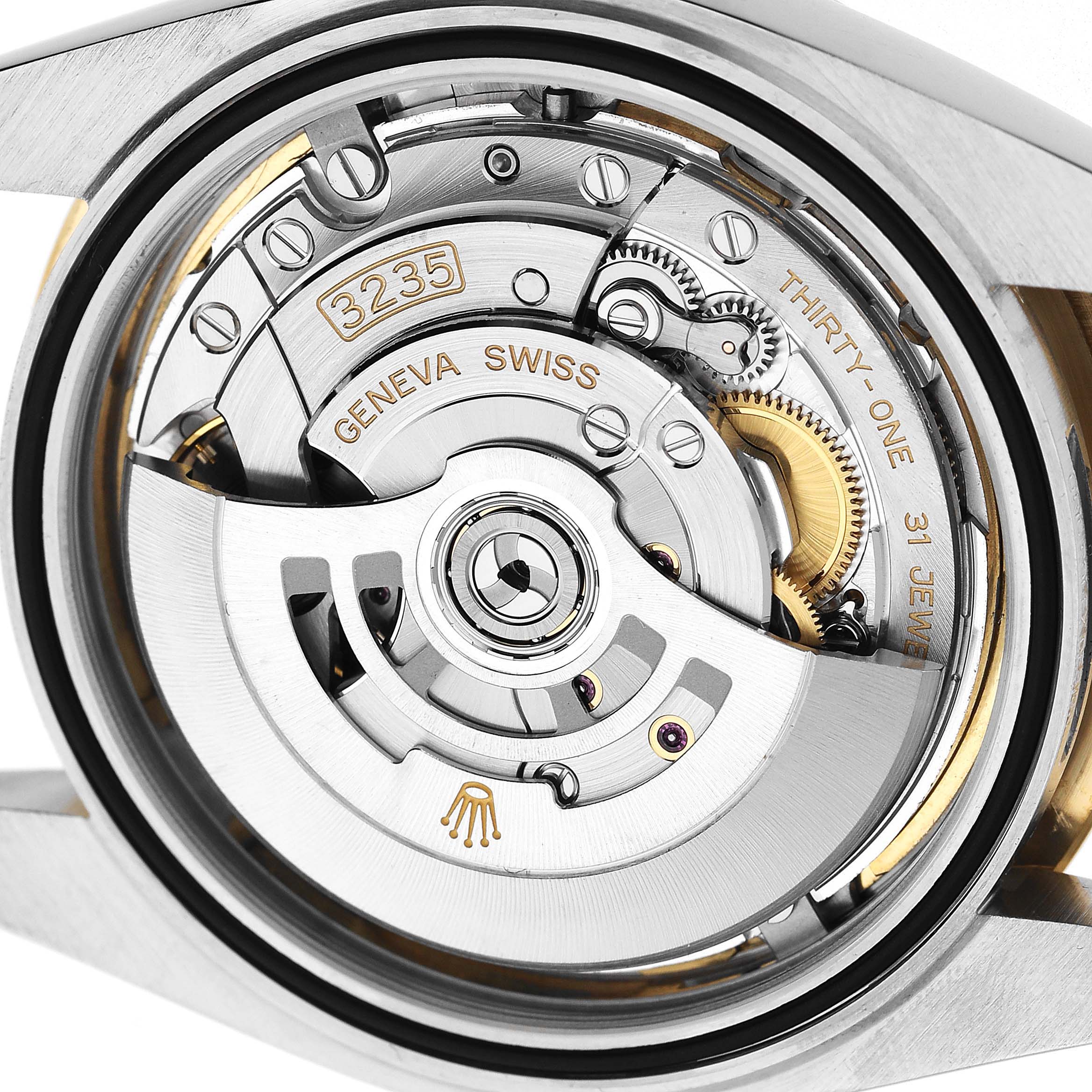The image shows the movement and intricate components of the Rolex Datejust 41 126333 Men's Steel and Gold (two tone) Champagne Dial from the case back.