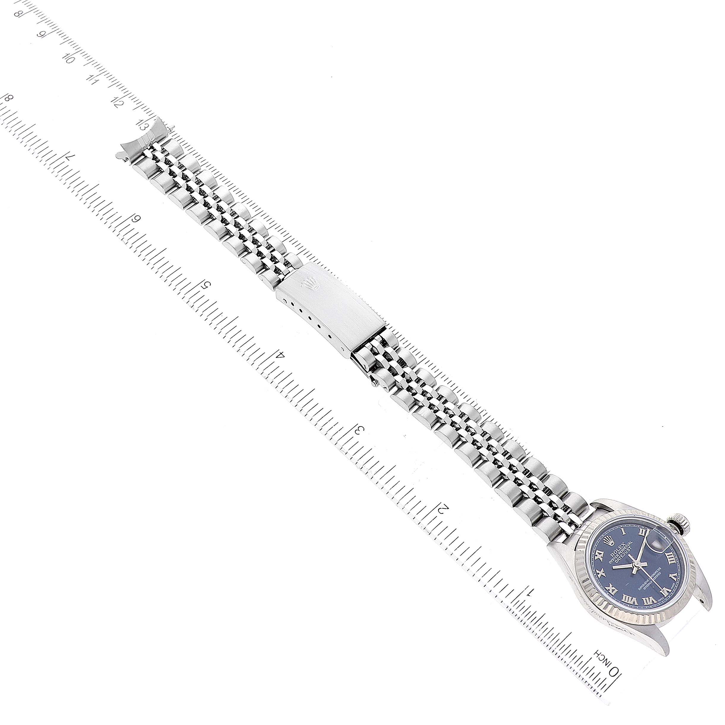 The image shows a Rolex Datejust 79174 Women's Stainless Steel Blue Dial 79174 Women's Stainless Steel Blue Dial watch taken from a top-down angle, displaying its dial and bracelet along a measuring ruler.