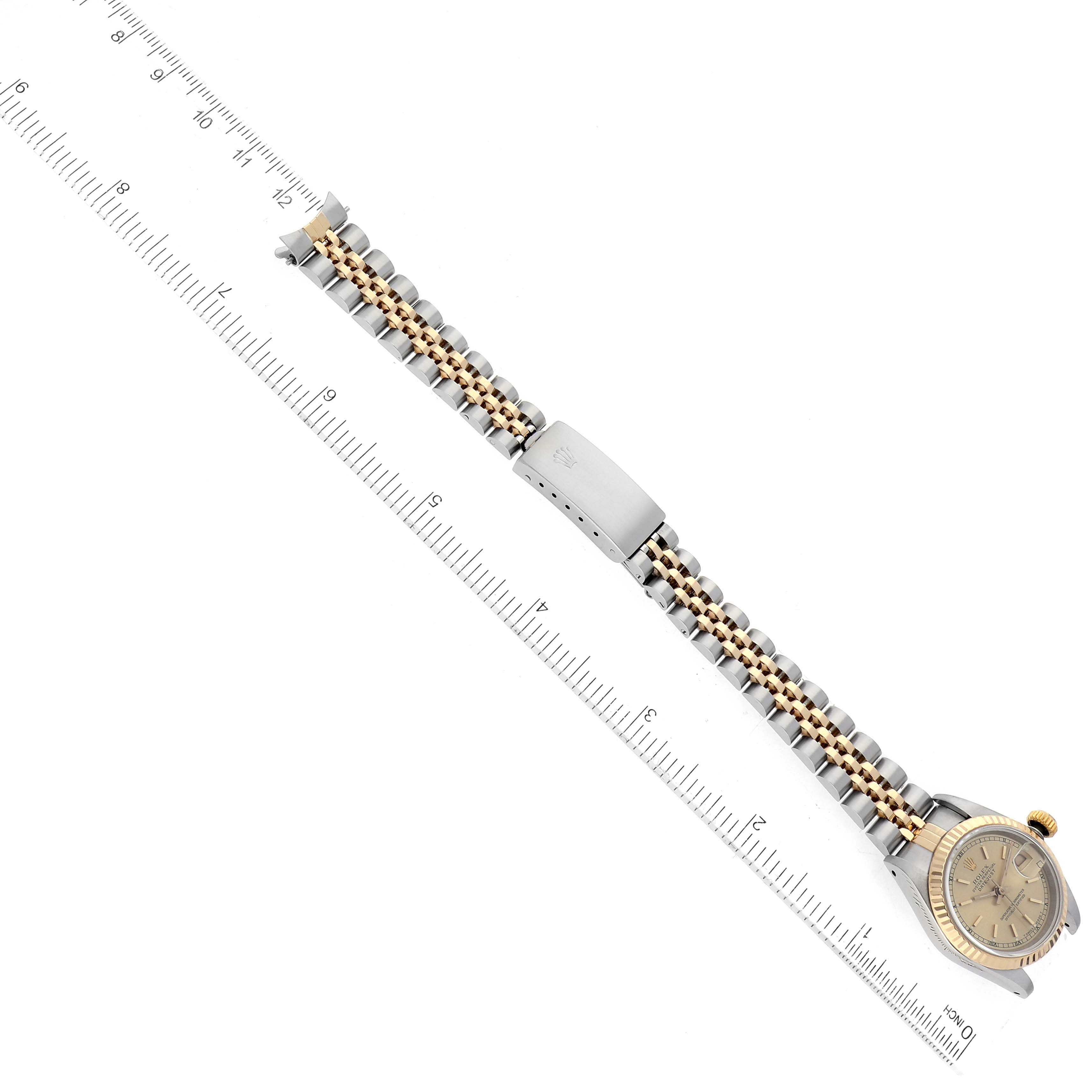The image shows a top-down view of a Rolex Datejust 69173 Women's Steel and Gold (two tone) Beige Dial 69173 Women's Steel and Gold (two tone) Beige Dial watch, displaying its bracelet, clasp, and case with a ruler for scale.