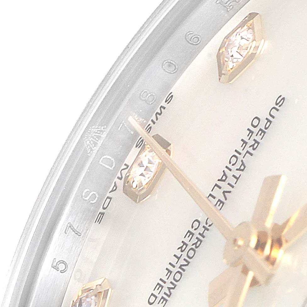 The image shows a close-up of the dial, diamond hour markers, and hands of a Mid-Size Rolex watch.