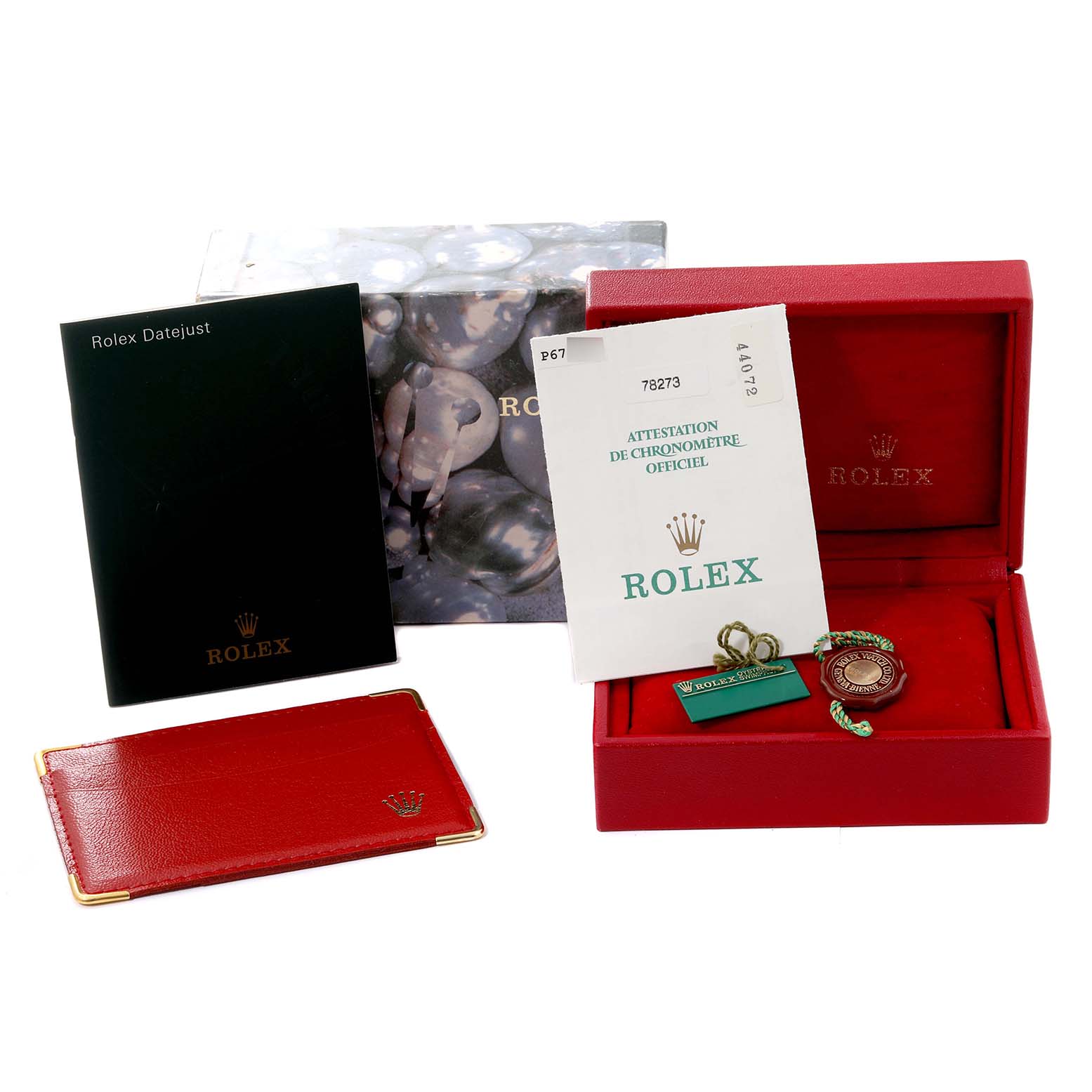 The image shows various accessories for a Rolex Mid-Size 78273 Women's Steel and Gold (two tone) Red Dial 78273 Women's Steel and Gold (two tone) Red Dial model including manuals, official certification, tags, and a red watch case.