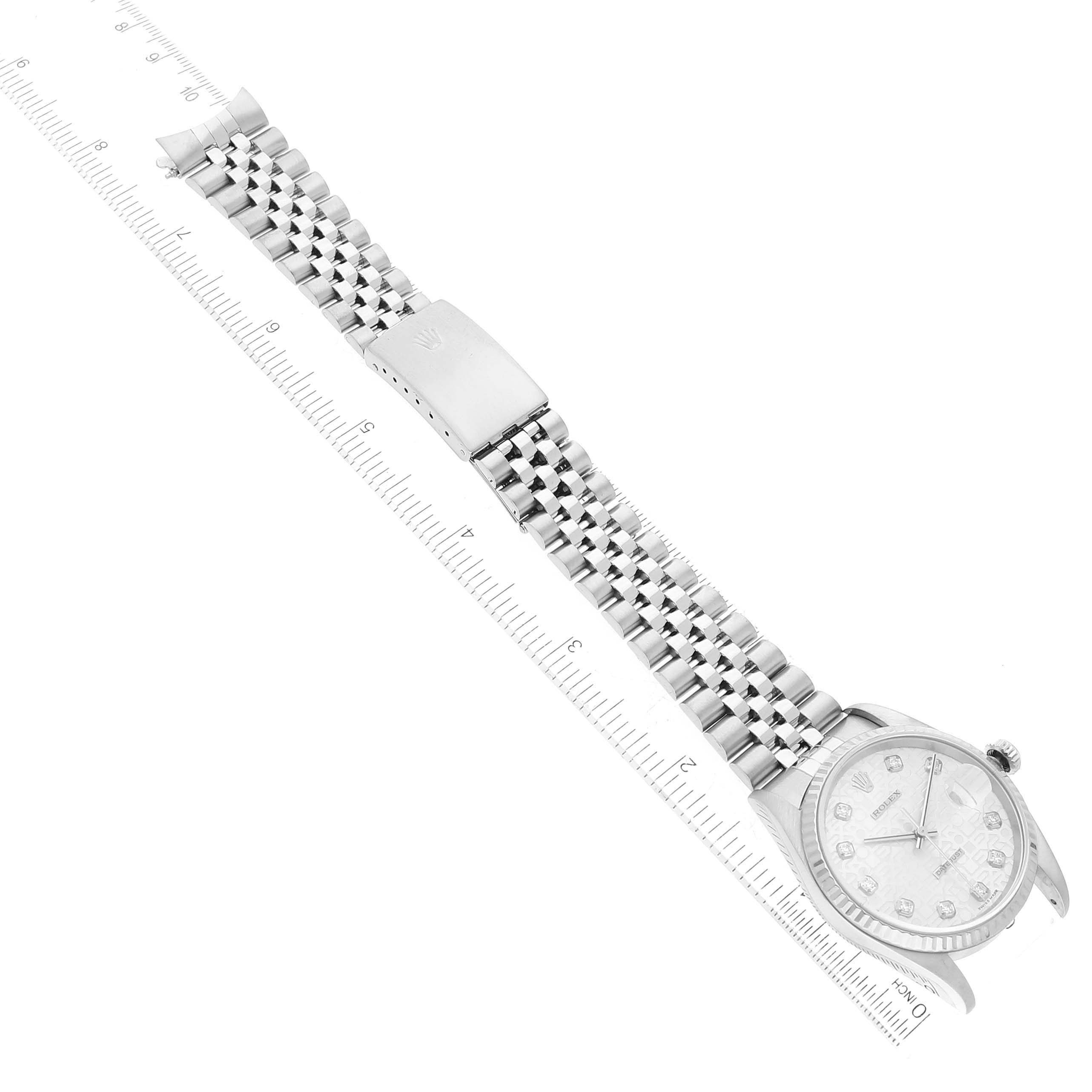 The image shows a top-down view of a Rolex Datejust 16234 Men's Stainless Steel Silver Dial 16234 Men's Stainless Steel Silver Dial watch, highlighting its bracelet and clasp with a ruler for scale.