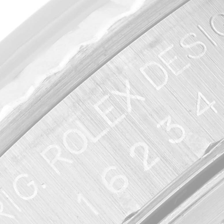 The image shows a close-up of the engraved serial number and "Rolex Design" on the side of the Rolex Datejust 16234 Men's Stainless Steel Silver Dial 16234 Men's Stainless Steel Silver Dial model case.