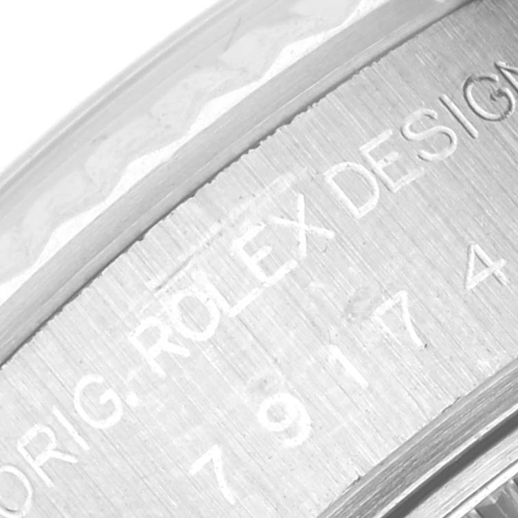 The image shows a close-up of the engraving on the case back of a Rolex Datejust 79174 Women's Stainless Steel Mother of Pearl Dial 79174 Women's Stainless Steel Mother of Pearl Dial watch.