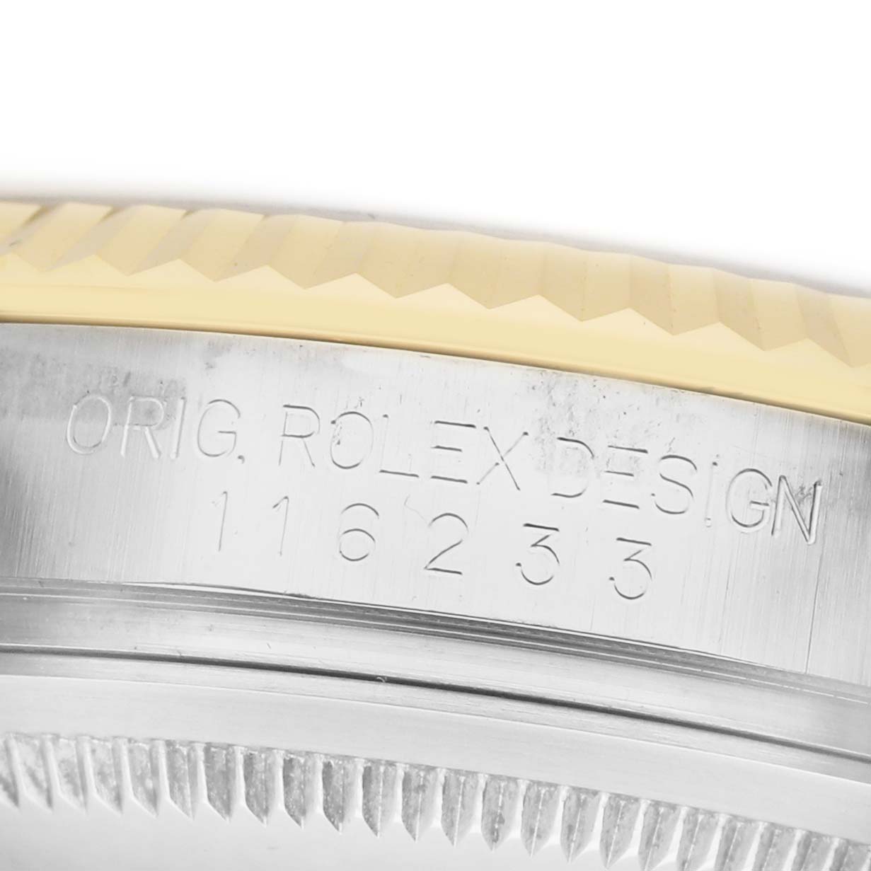 The image shows a close-up of the Rolex Datejust 116233 Men's Steel and Gold (two tone) Black Dial model's case side featuring engraved text and part of the bezel.
