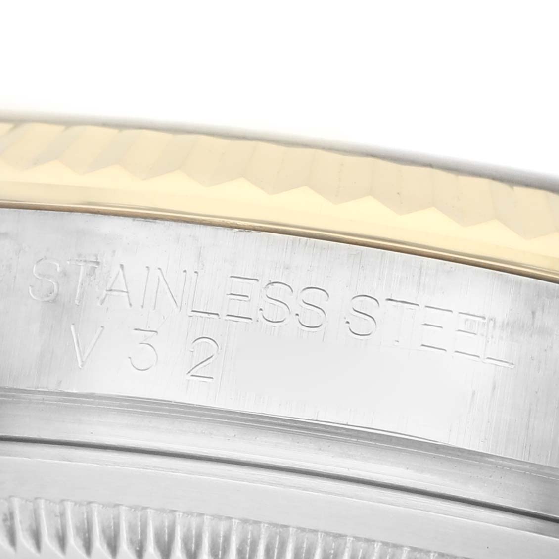 The image shows a close-up of the case detailing of a Rolex Datejust 116233 Men's Steel and Gold (two tone) Black Dial watch, highlighting the stainless steel engraving.