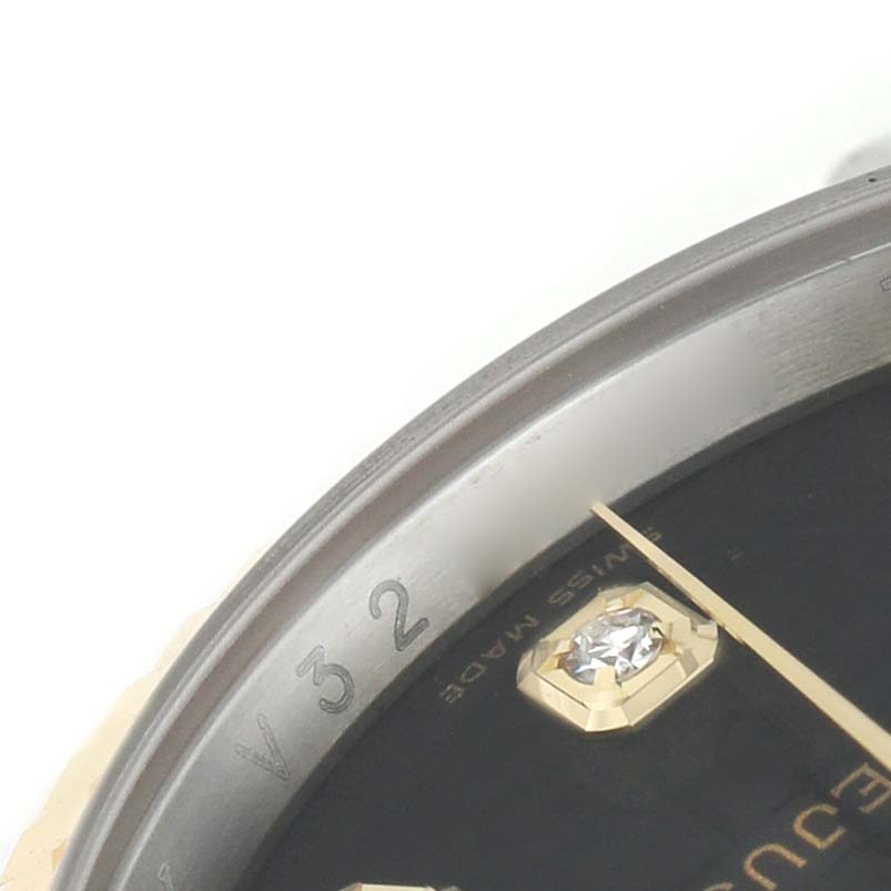 The image shows a close-up of the bezel and dial of a Rolex Datejust 116233 Men's Steel and Gold (two tone) Black Dial, highlighting a diamond marker and watch hands.
