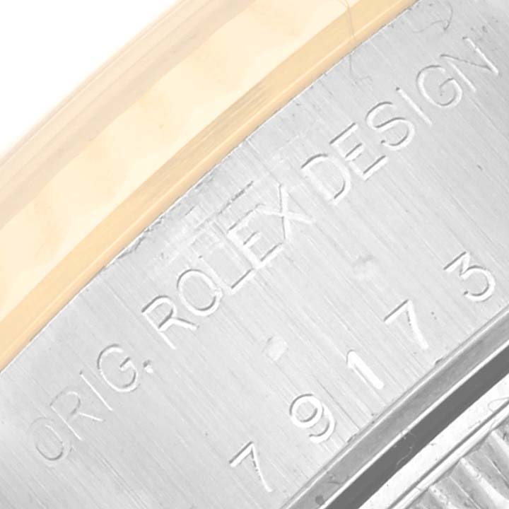 This is a close-up view of the case side engraving on a Rolex Datejust 79173 Women's Steel and Gold (two tone) Beige Dial 79173 Women's Steel and Gold (two tone) Beige Dial watch.
