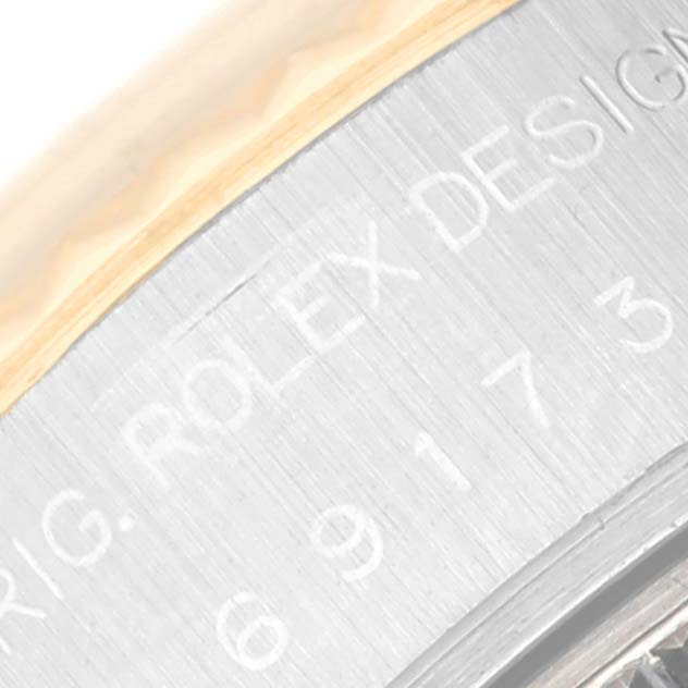 The image shows a close-up angle of the case side with the engraving "ROLEX DESIGN" on a Rolex Datejust 69173 Women's Steel and Gold (two tone) Blue Dial 69173 Women's Steel and Gold (two tone) Blue Dial model watch.