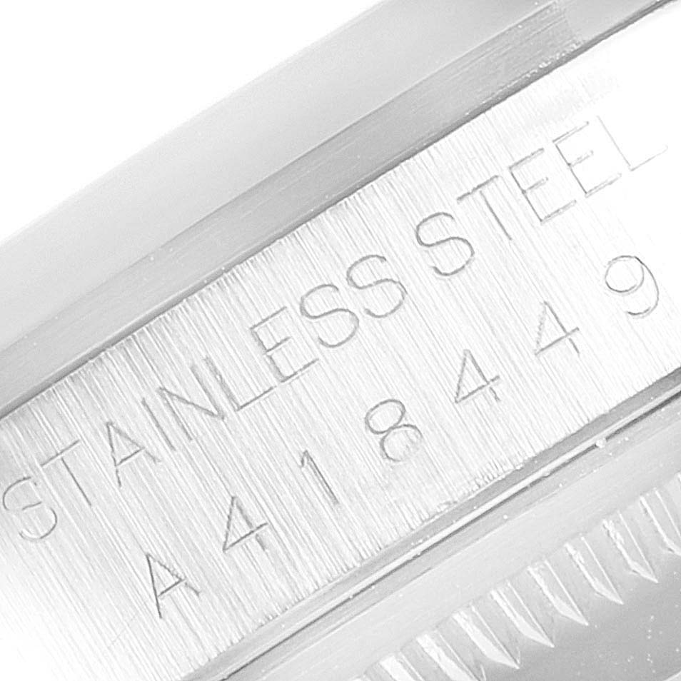 The image shows a close-up of the case side of a Rolex Datejust 16200 Men's Stainless Steel White Dial 16200 Men's Stainless Steel White Dial watch, highlighting its stainless steel material and serial number.