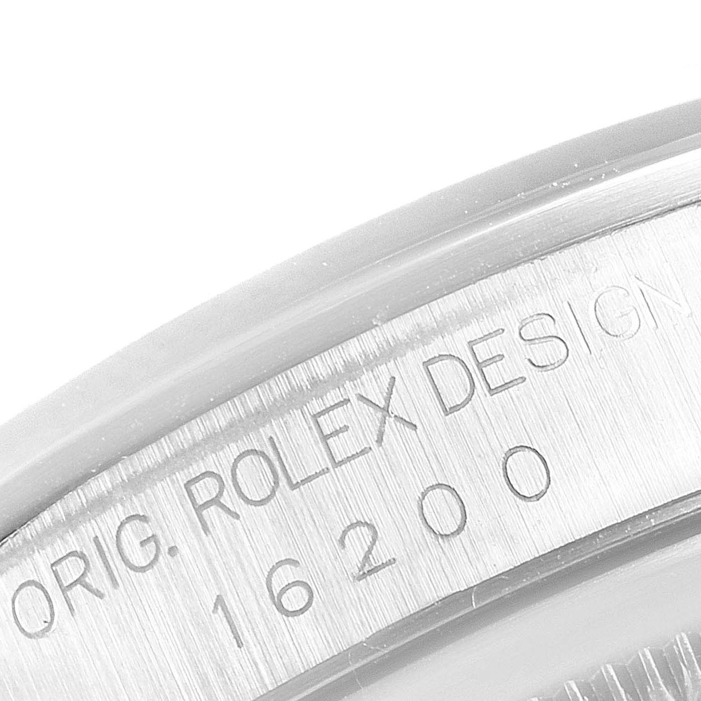 The image shows a close-up view of a Rolex Datejust 16200 Men's Stainless Steel White Dial 16200 Men's Stainless Steel White Dial model, focusing on the engraved serial number and "ORIG. ROLEX DESIGN" text.