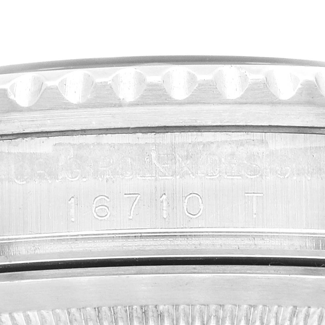 This image shows a close-up of the side of a Rolex GMT-Master 16710 Men
s Stainless Steel Black Dial 16710 Men
s Stainless Steel Black Dial watch case, highlighting the engraved model number 16710 T.