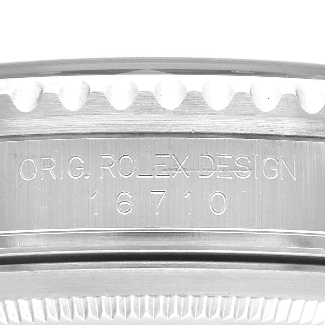 The image shows a close-up of the case side of a Rolex GMT-Master 16710 Men's Stainless Steel Black Dial 16710 Men's Stainless Steel Black Dial model, highlighting its engraved design number 16710.