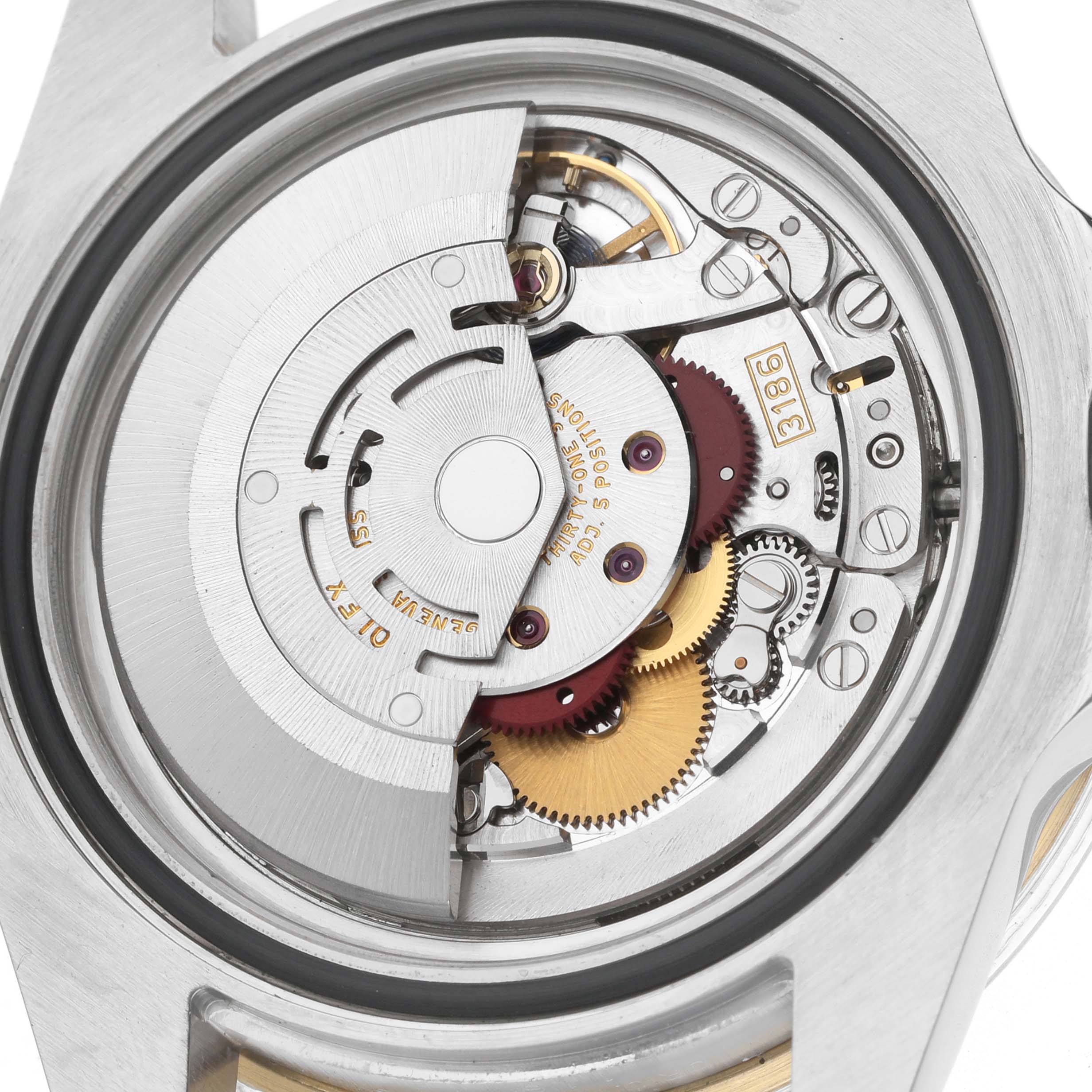 The image shows the movement of a Rolex GMT-Master M116713LN Men's Steel and Gold (two tone) Black Dial watch with visible gears and rotor from a back angle.