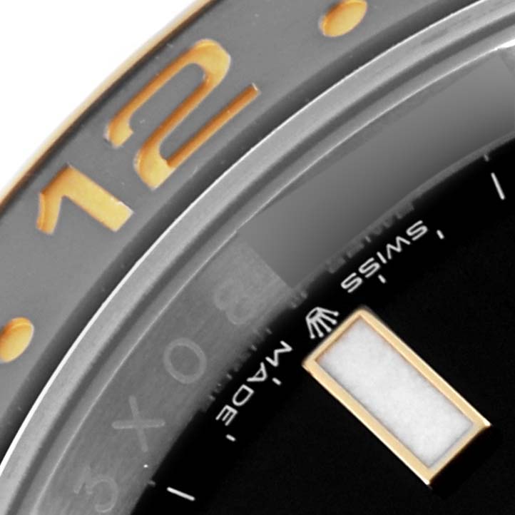 The image shows a close-up of the bezel, part of the dial, hour marker, and "SWISS MADE" text of a Rolex GMT-Master 126713 Men's Steel and Gold (two tone) Black Dial 126713 Men's Steel and Gold (two tone) Black Dial watch.