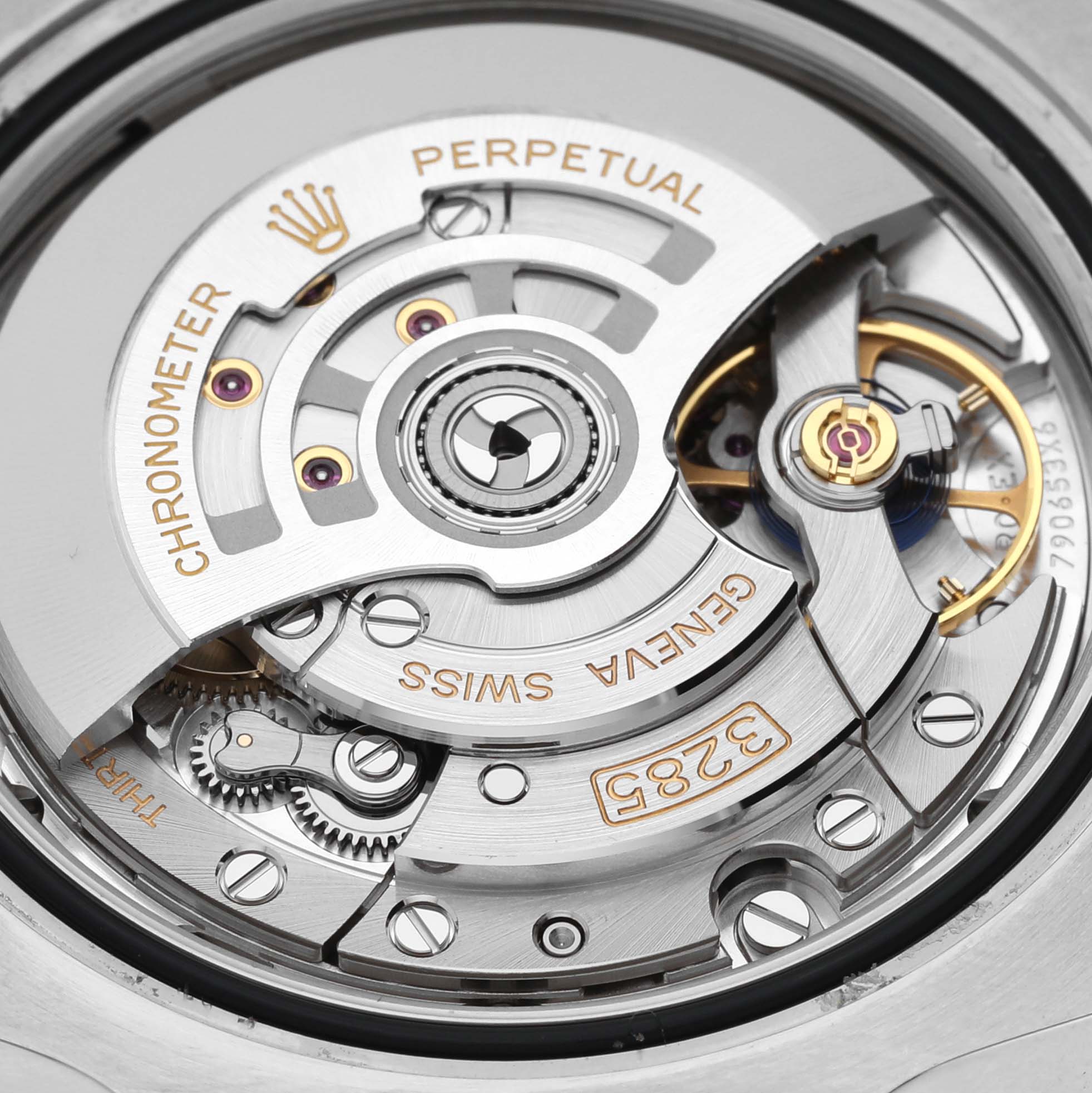 The image shows the internal mechanism of a Rolex GMT-Master 126713 Men's Steel and Gold (two tone) Black Dial 126713 Men's Steel and Gold (two tone) Black Dial watch at a close-up angle, highlighting the rotor and gears.