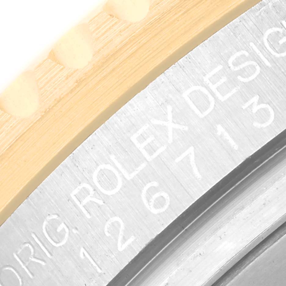 This image shows a close-up of the case back edge and serial number engraving on a Rolex GMT-Master 126713 Men's Steel and Gold (two tone) Black Dial 126713 Men's Steel and Gold (two tone) Black Dial watch.