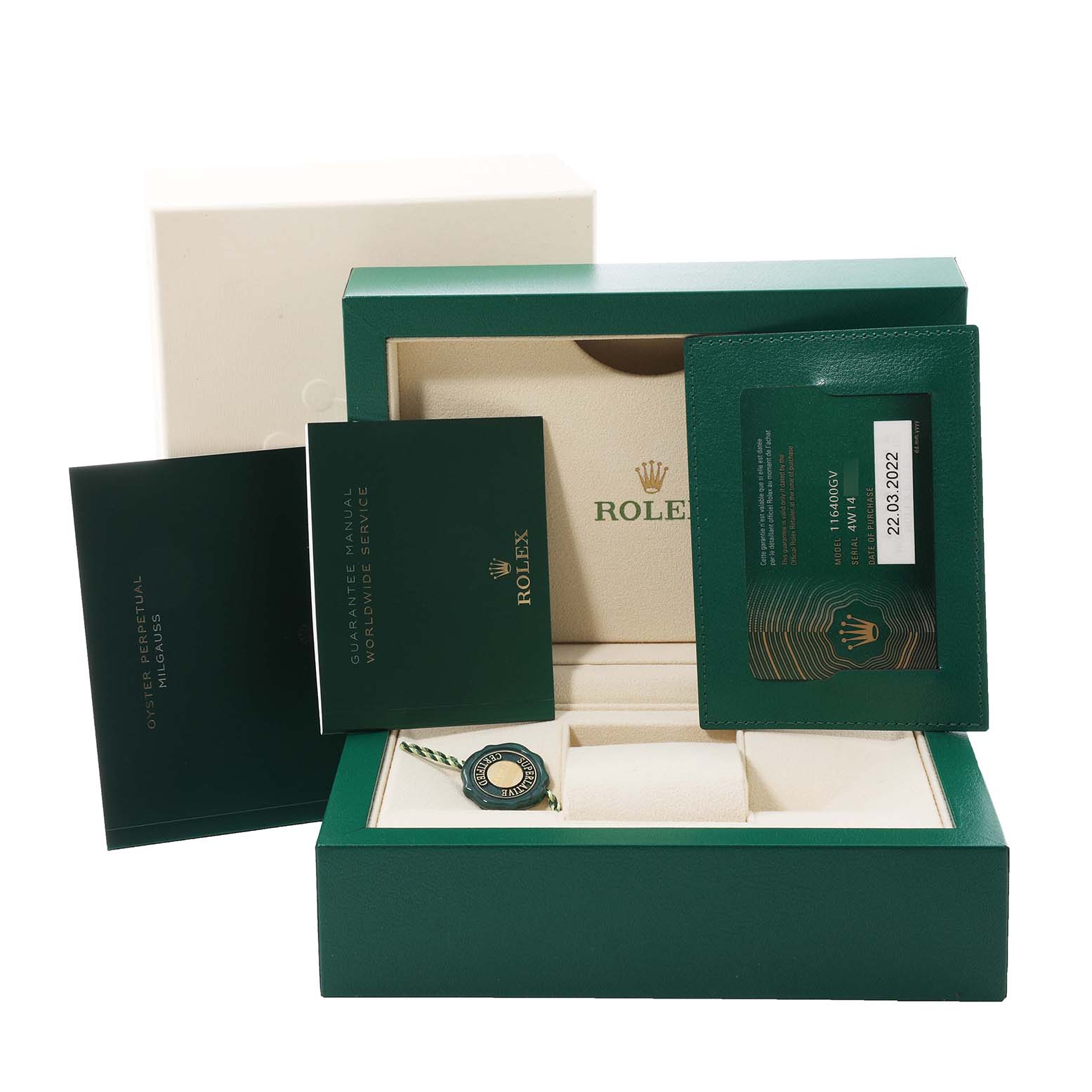 This image shows the packaging and accessories for a Rolex Milgauss 116400 Men's Stainless Steel Blue Dial 116400 Men's Stainless Steel Blue Dial watch, including the box, papers, and warranty card.