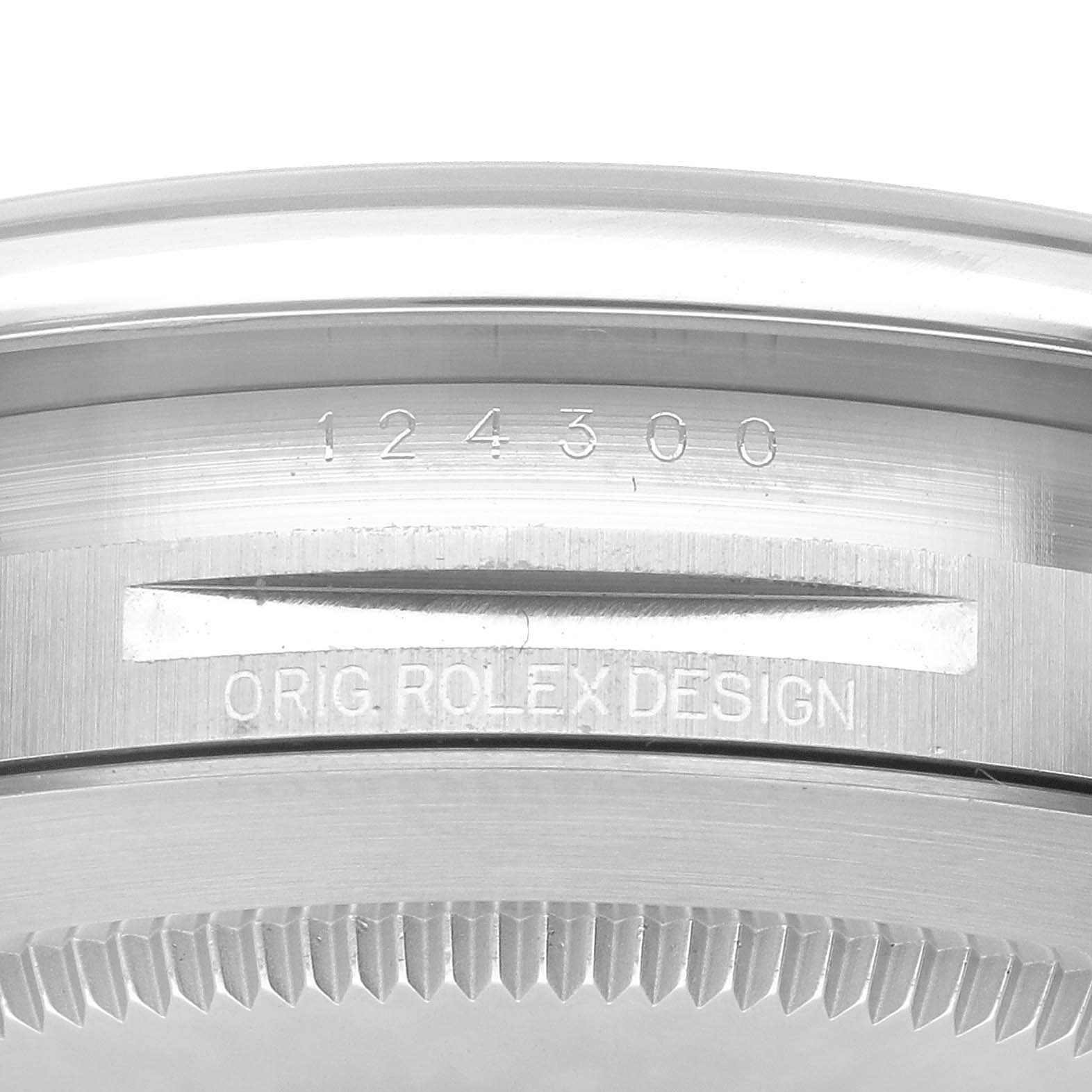 This image shows a close-up of the side of the case of a Rolex Oyster Perpetual 124300 Men
s Stainless Steel Silver Dial 124300 Men
s Stainless Steel Silver Dial watch, highlighting the model number "124300" and "ORIG ROLEX DESIGN."