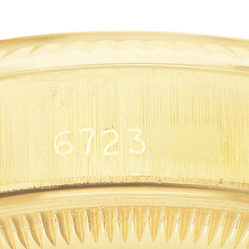 The image shows an angled close-up of the side of a Rolex President 6917 Women's Yellow Gold Champagne Dial model, highlighting the serial number engraving.