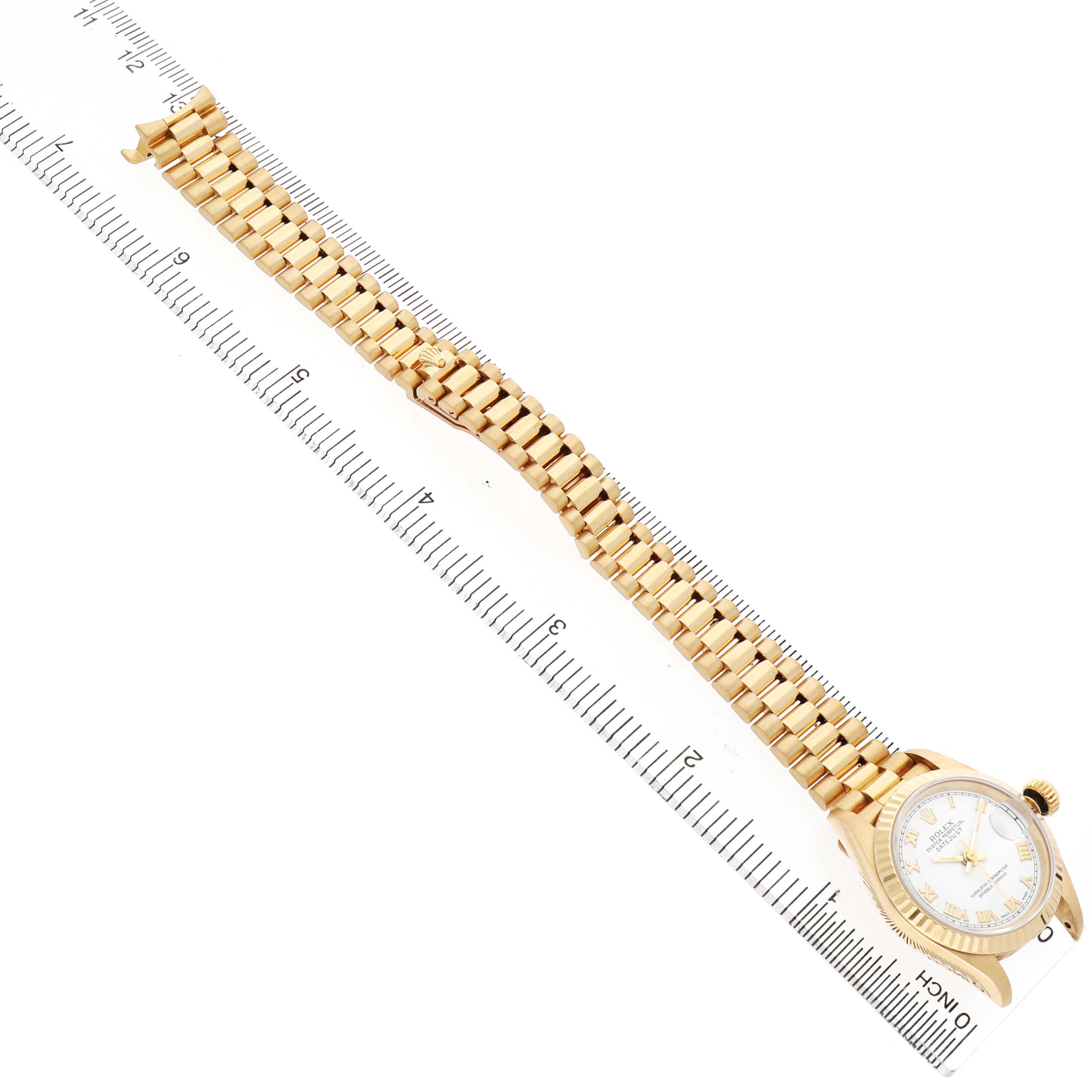 The Rolex President 69178 Women's Yellow Gold White Dial watch is shown from a top-down angle, displaying the full bracelet and watch face.